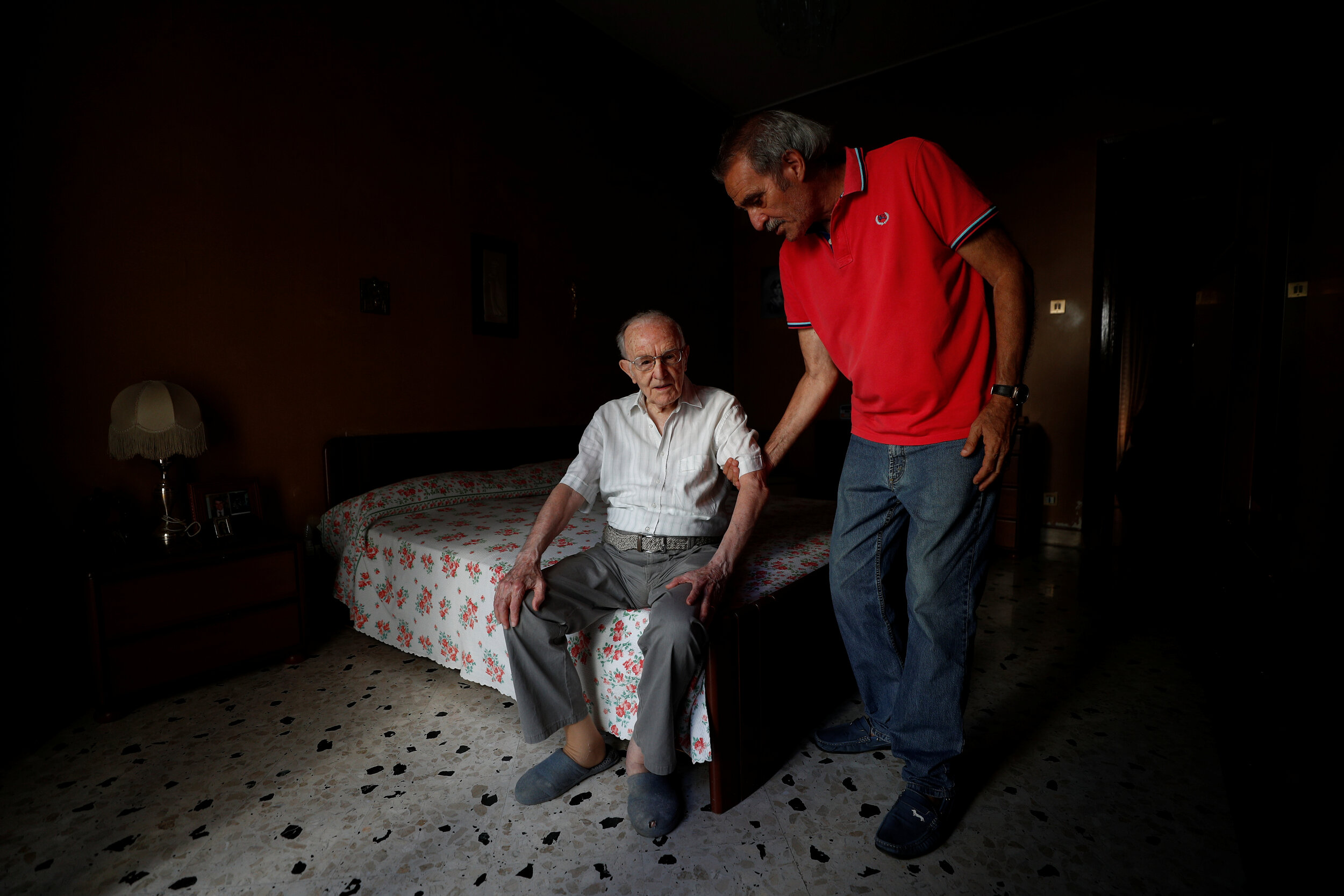  Giuseppe Paterno, 96, Italy's oldest student, is helped by his son Ninni Paterno, 72, to get up from his bed, two days before he graduates from The University of Palermo with an undergraduate degree in history and philosophy, at Paterno's home in Pa