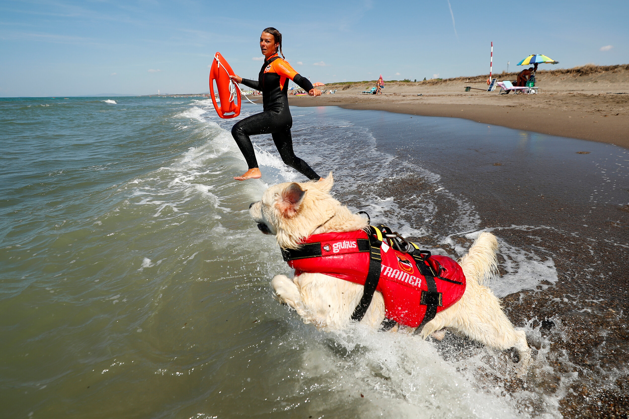  A member of an all-female group of canine rescuers from the Italian School of Rescue Dogs (La Scuola Italiana Cani Salvataggio) attends a training session with her dog before patrolling the beach to ensure swimmers can enjoy their time at the sea in