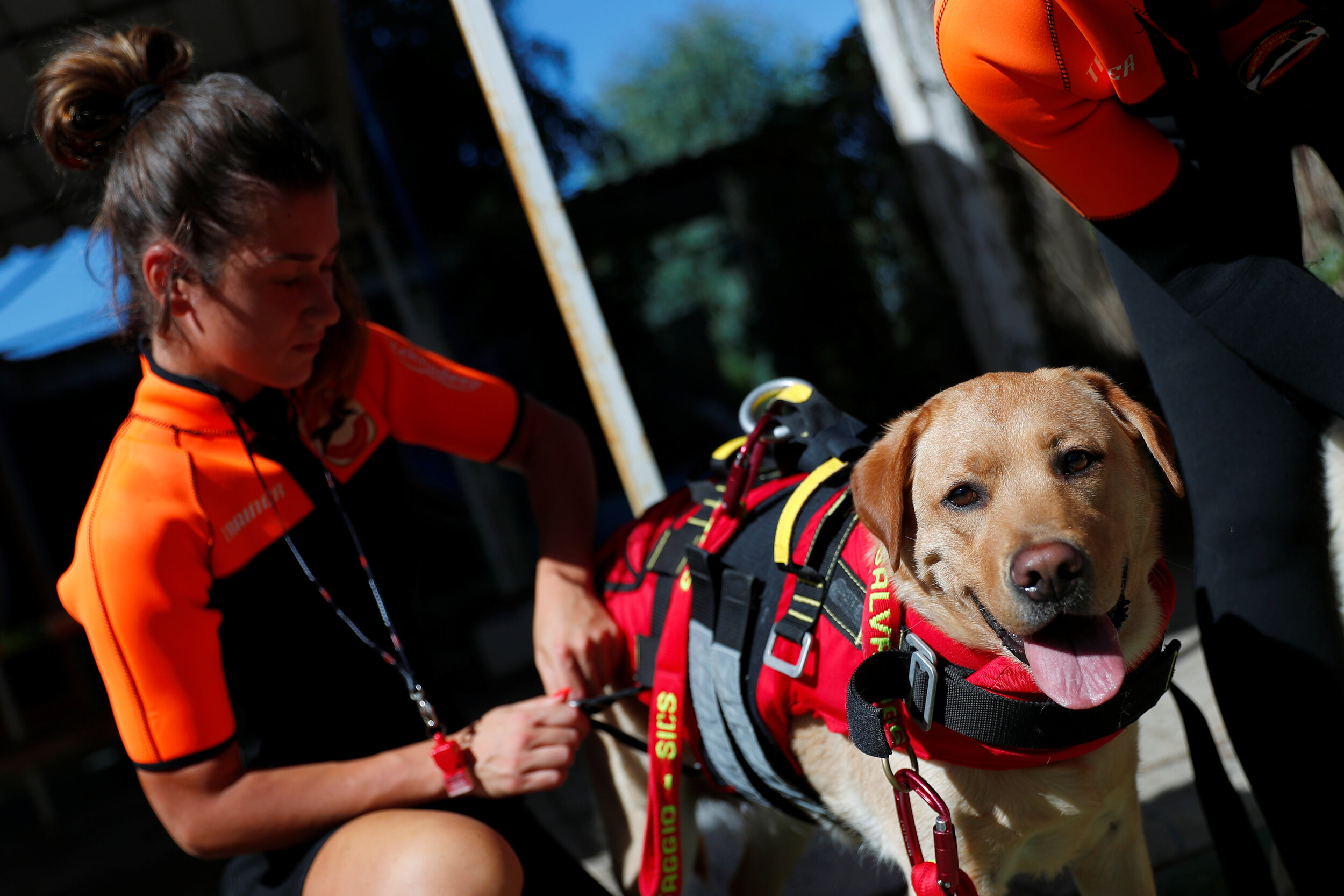  A member of an all-female group of canine rescuers from the Italian School of Rescue Dogs (La Scuola Italiana Cani Salvataggio) gets ready to attend a training session with her dog before patrolling the beach to ensure swimmers can enjoy their time 