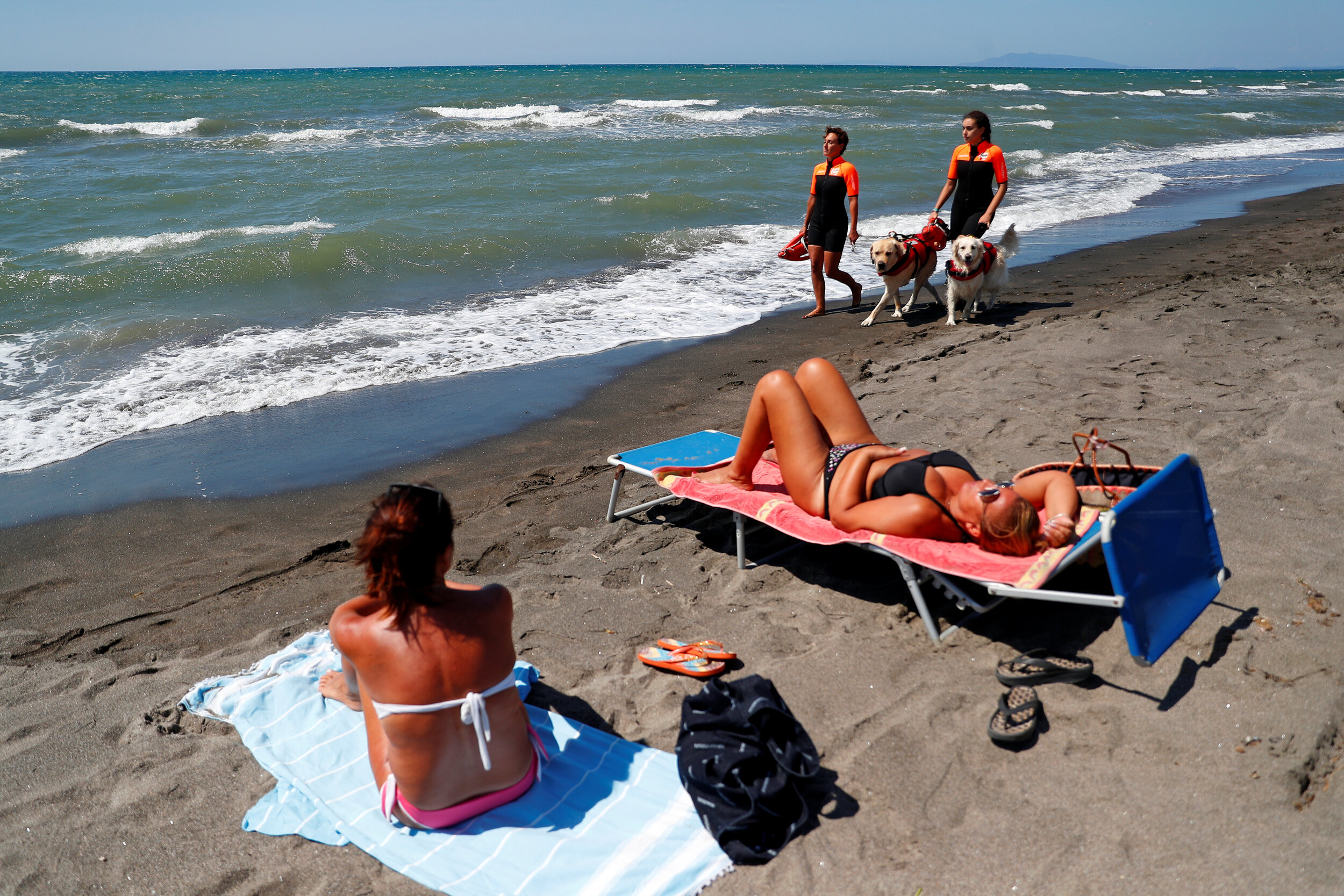  Members of an all-female group of canine rescuers from the Italian School of Rescue Dogs (La Scuola Italiana Cani Salvataggio) patrol the beach with their dogs to ensure swimmers can enjoy their time at the sea in safety, in Riva dei Tarquini, near 