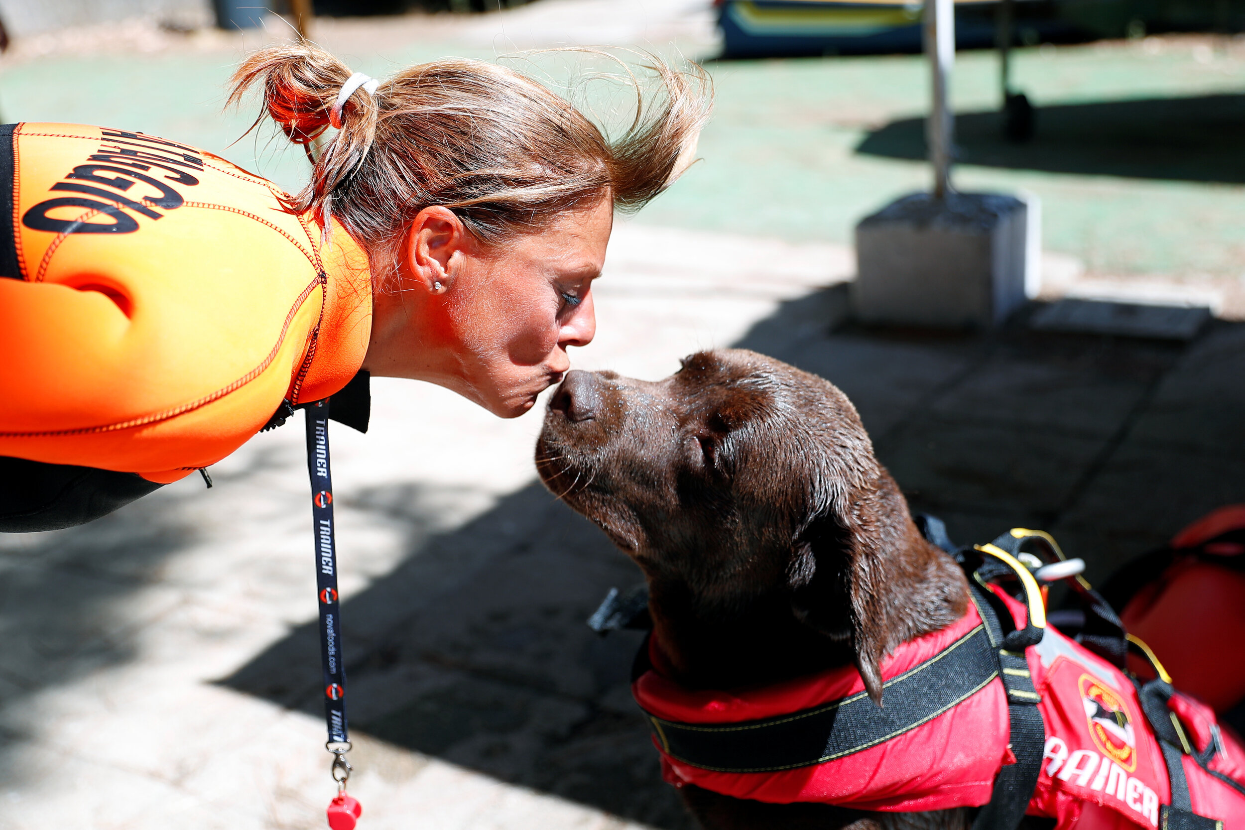  A member of an all-female group of canine rescuers from the Italian School of Rescue Dogs (La Scuola Italiana Cani Salvataggio) kisses her dog after they attended a training session before patrolling the beach to ensure swimmers can enjoy their time