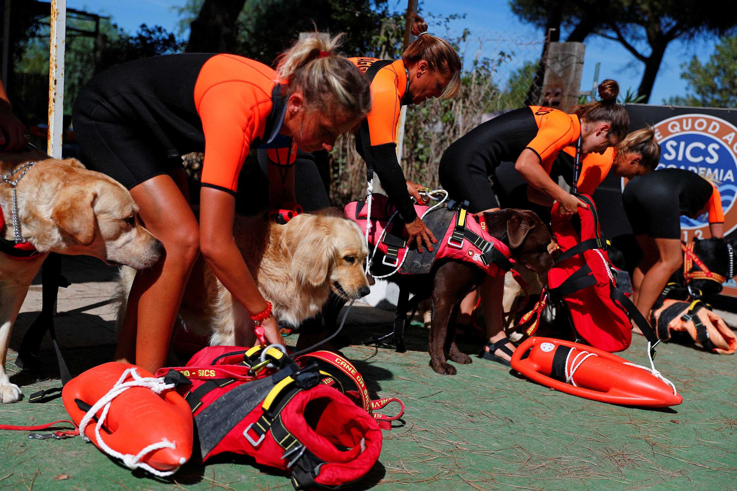  Members of an all-female group of canine rescuers from the Italian School of Rescue Dogs (La Scuola Italiana Cani Salvataggio) get ready to attend a training session with their dogs before patrolling the beach to ensure swimmers can enjoy their time