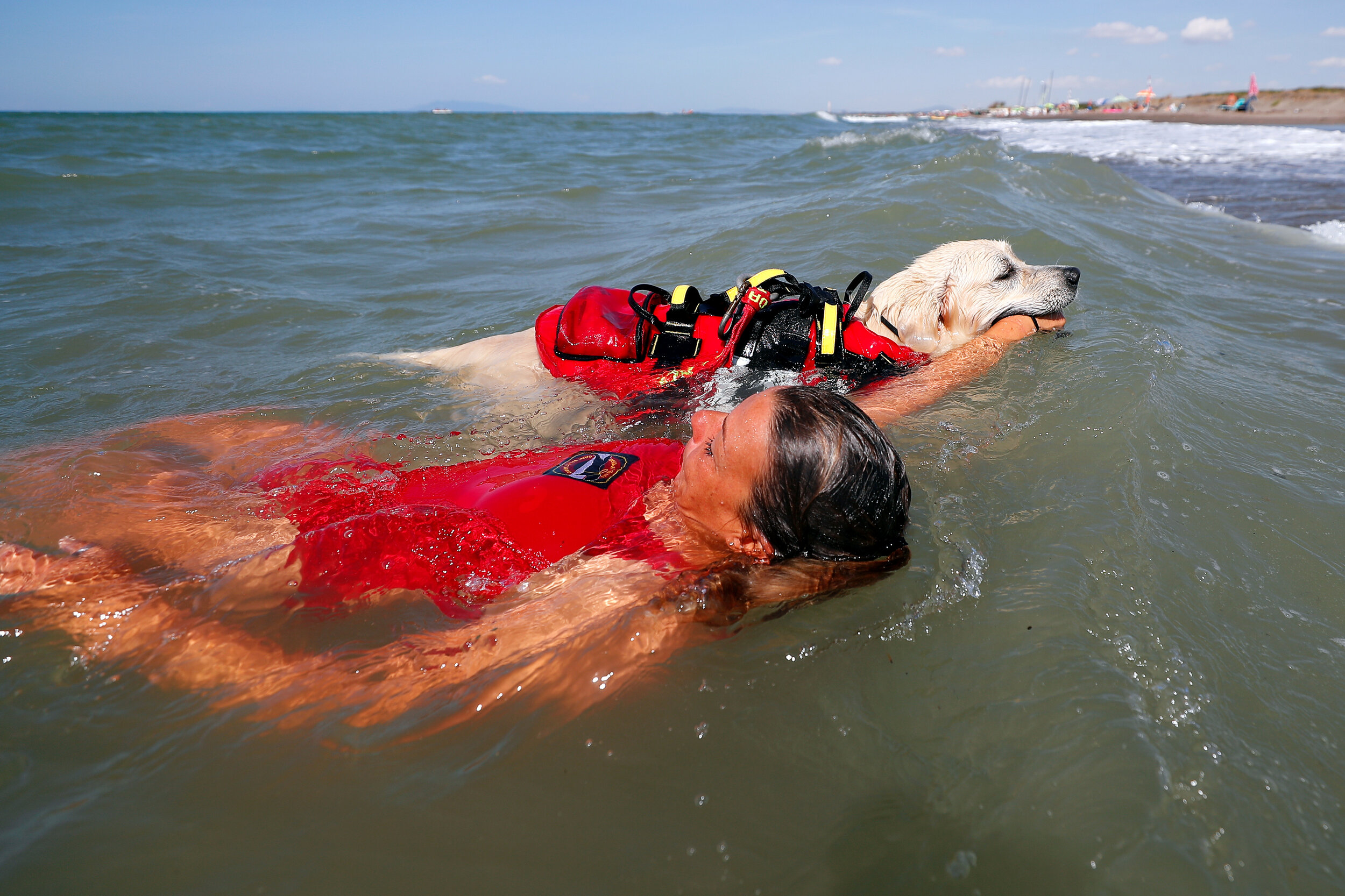  A member of an all-female group of canine rescuers from the Italian School of Rescue Dogs (La Scuola Italiana Cani Salvataggio) attends a training session with her dog before patrolling the beach to ensure swimmers can enjoy their time at the sea in