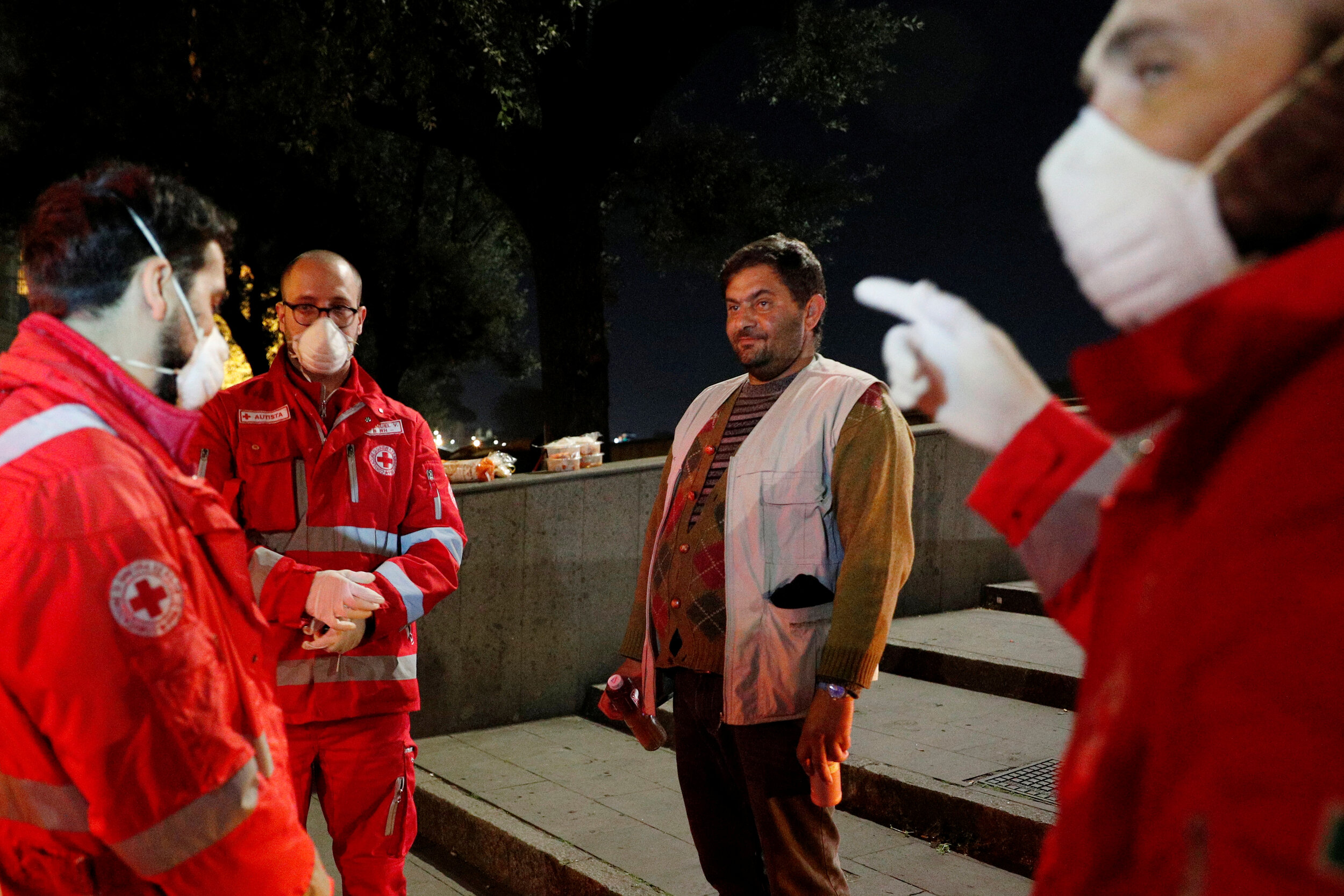  A homeless person is given bottles containing hot tea by the Red Cross in Rome, Italy, March 17, 2020. Since the coronavirus crisis, Red Cross workers have been increasing their daily activities to meet the growing needs of the homeless in Rome.  