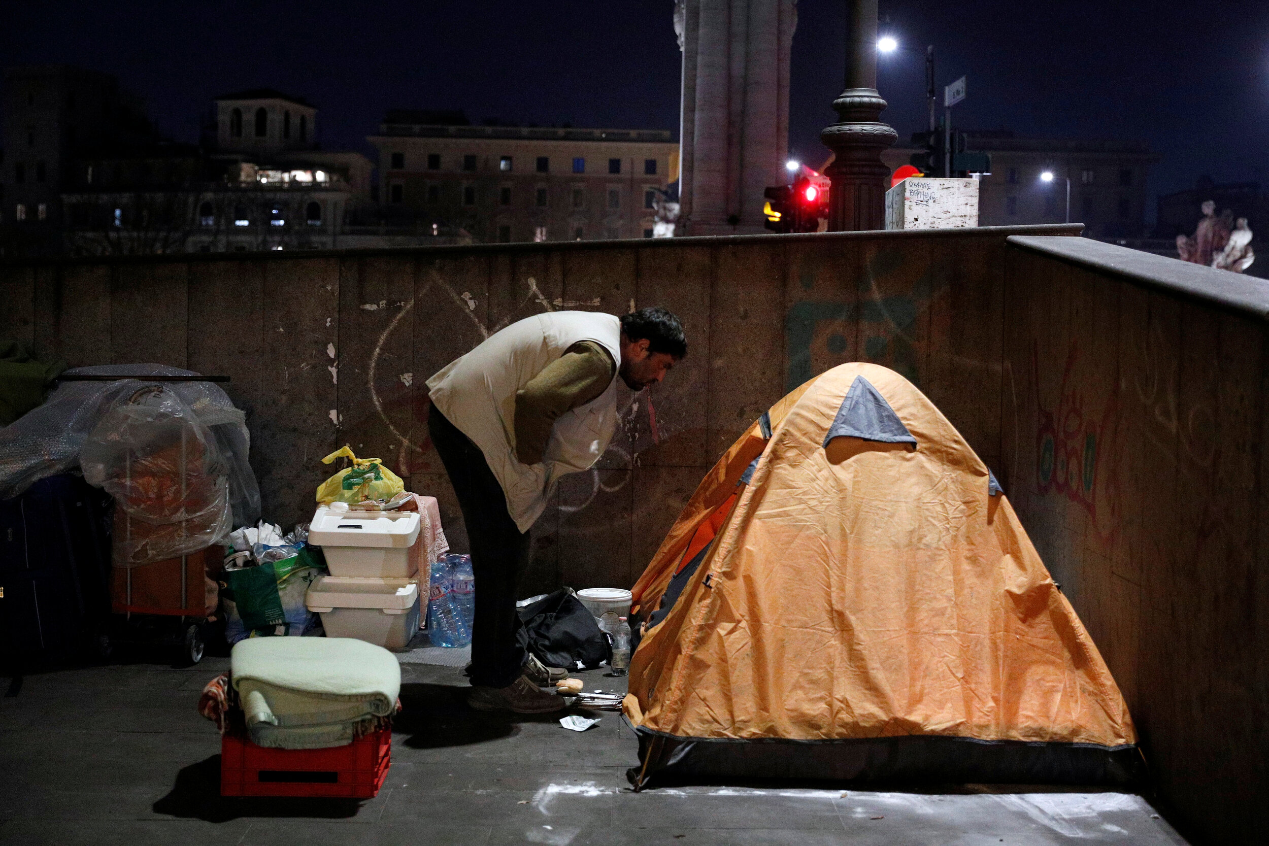  A homeless person looks inside his tent in Rome, Italy, March 17, 2020. Since the coronavirus crisis, Red Cross workers have been increasing their daily activities to meet the growing needs of the homeless in Rome.  