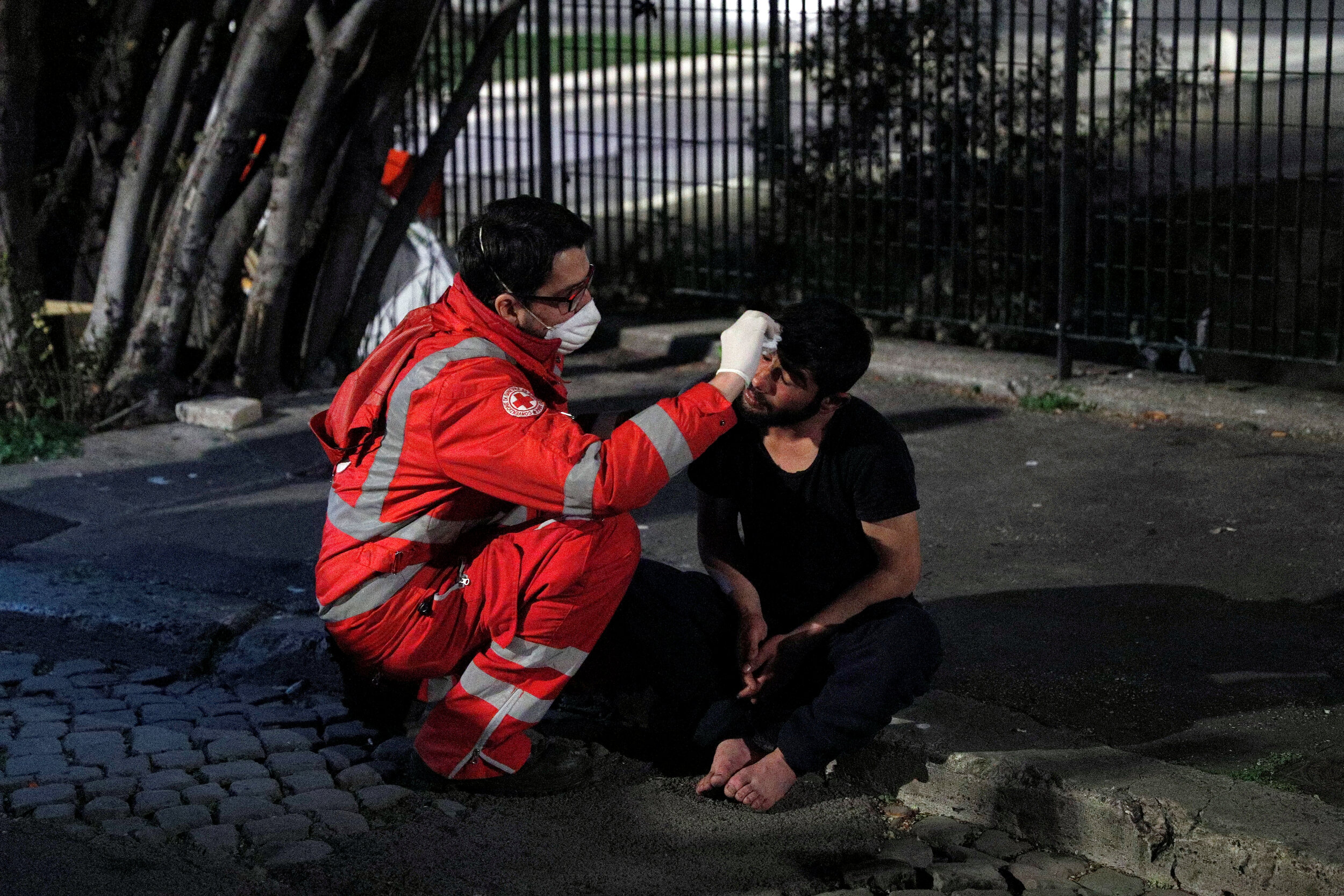  A homeless person is treated by a Red Cross worker in Rome, Italy, March 17, 2020. Since the coronavirus crisis, Red Cross workers have been increasing their daily activities to meet the growing needs of the homeless in Rome.  