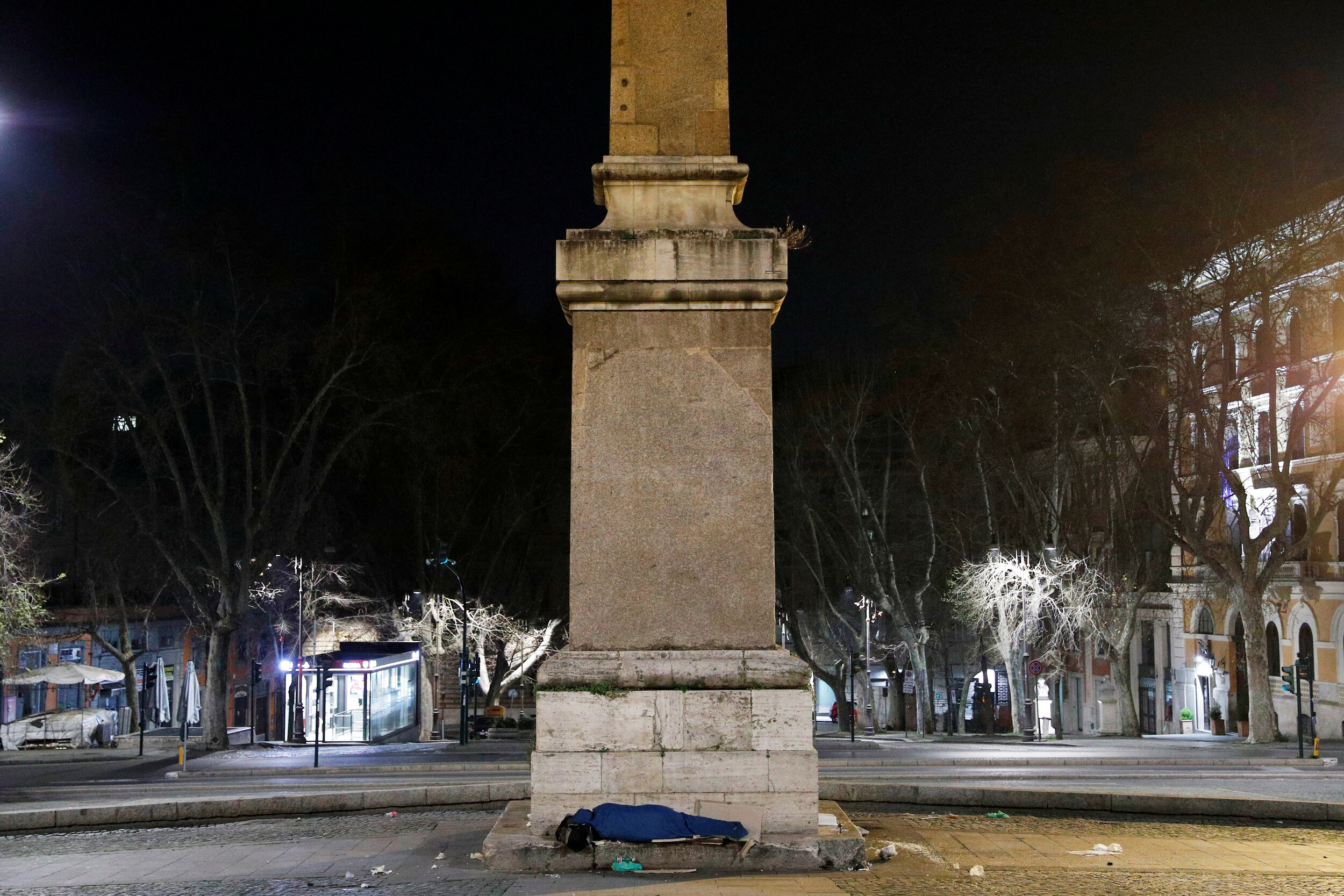  A homeless person sleeps on a street in Rome, Italy, March 17, 2020. Since the coronavirus crisis, Red Cross workers have been increasing their daily activities to meet the growing needs of the homeless in Rome. 