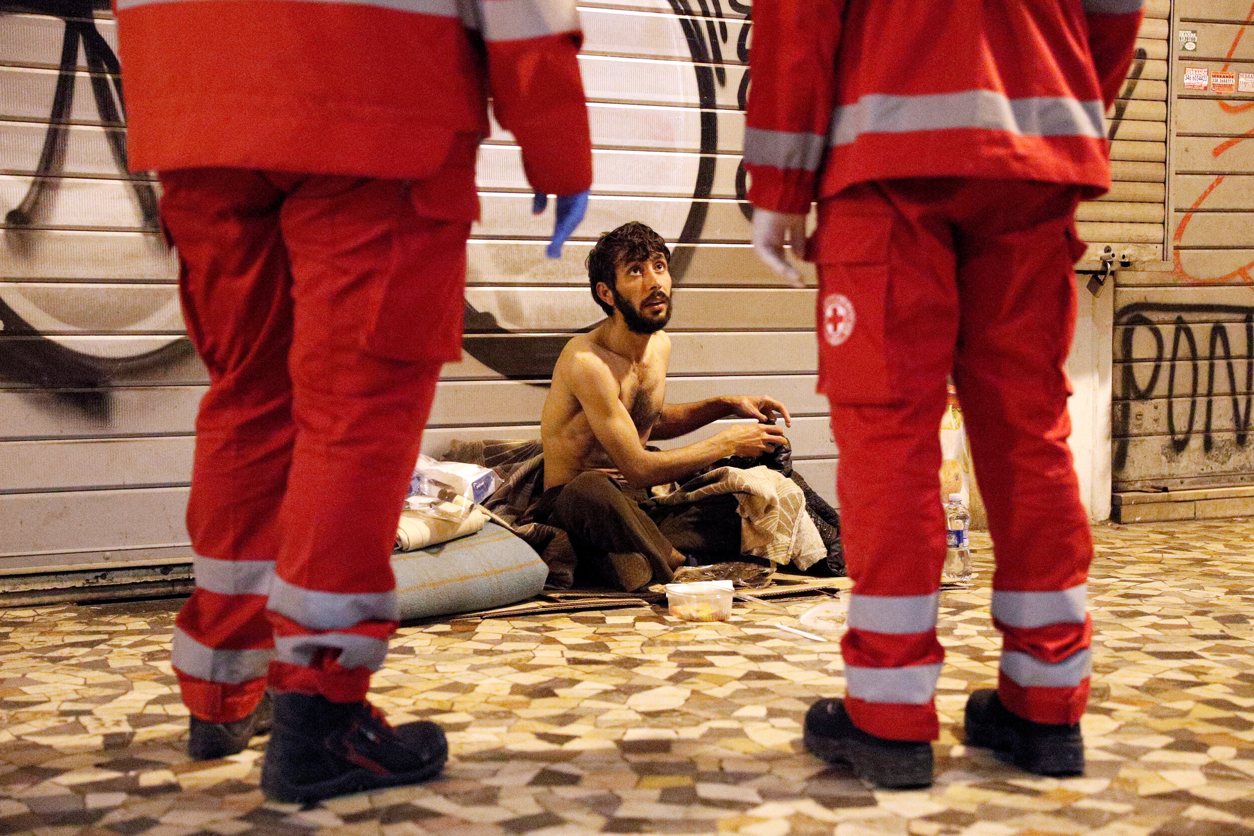  A homeless person talks to Red Cross workers in Rome, Italy, March 17, 2020. Since the coronavirus crisis, Red Cross workers have been increasing their daily activities to meet the growing needs of the homeless in Rome.  