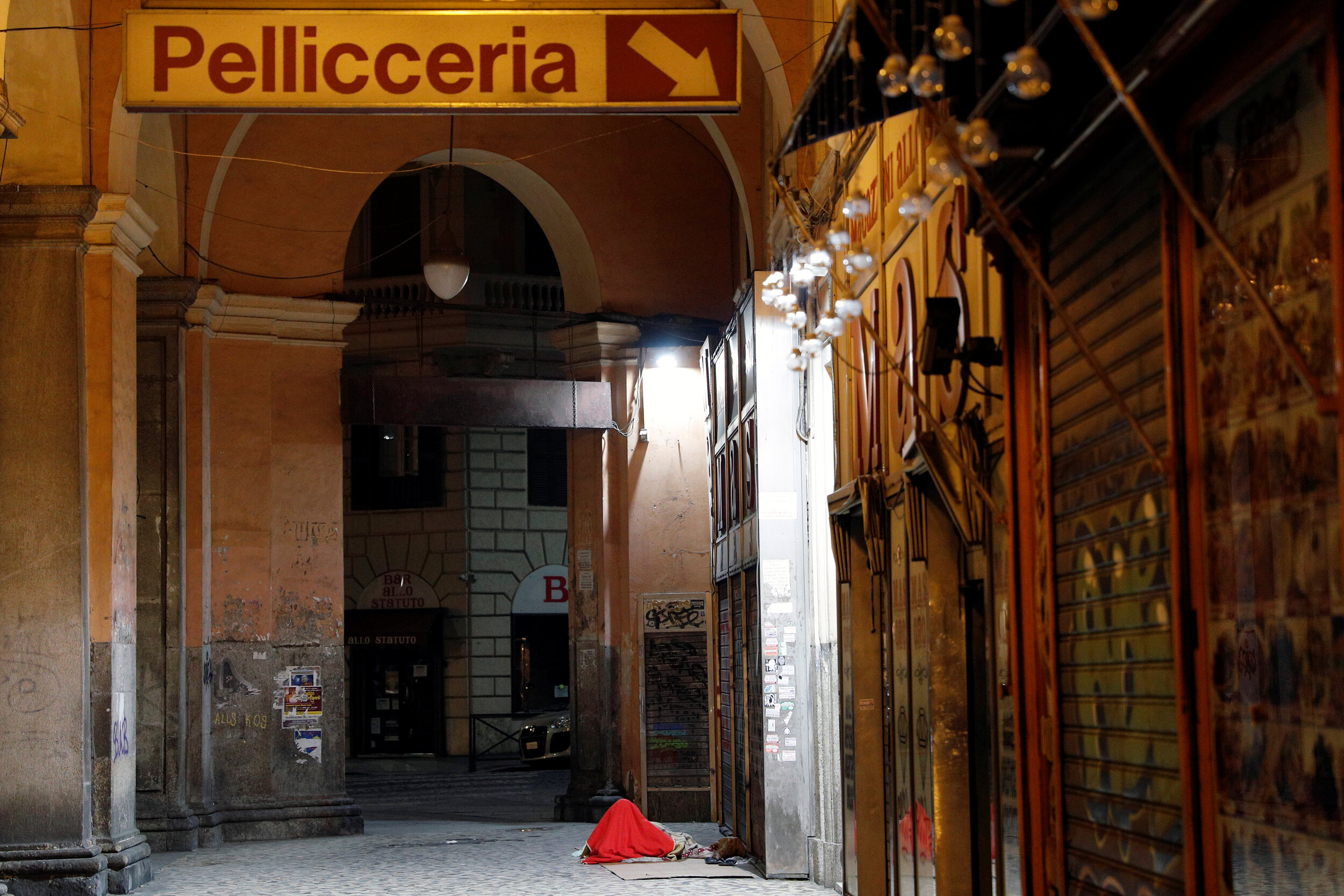  A homeless person sleeps on a street in Rome, Italy, March 17, 2020. Since the coronavirus crisis, Red Cross workers have been increasing their daily activities to meet the growing needs of the homeless in Rome. 