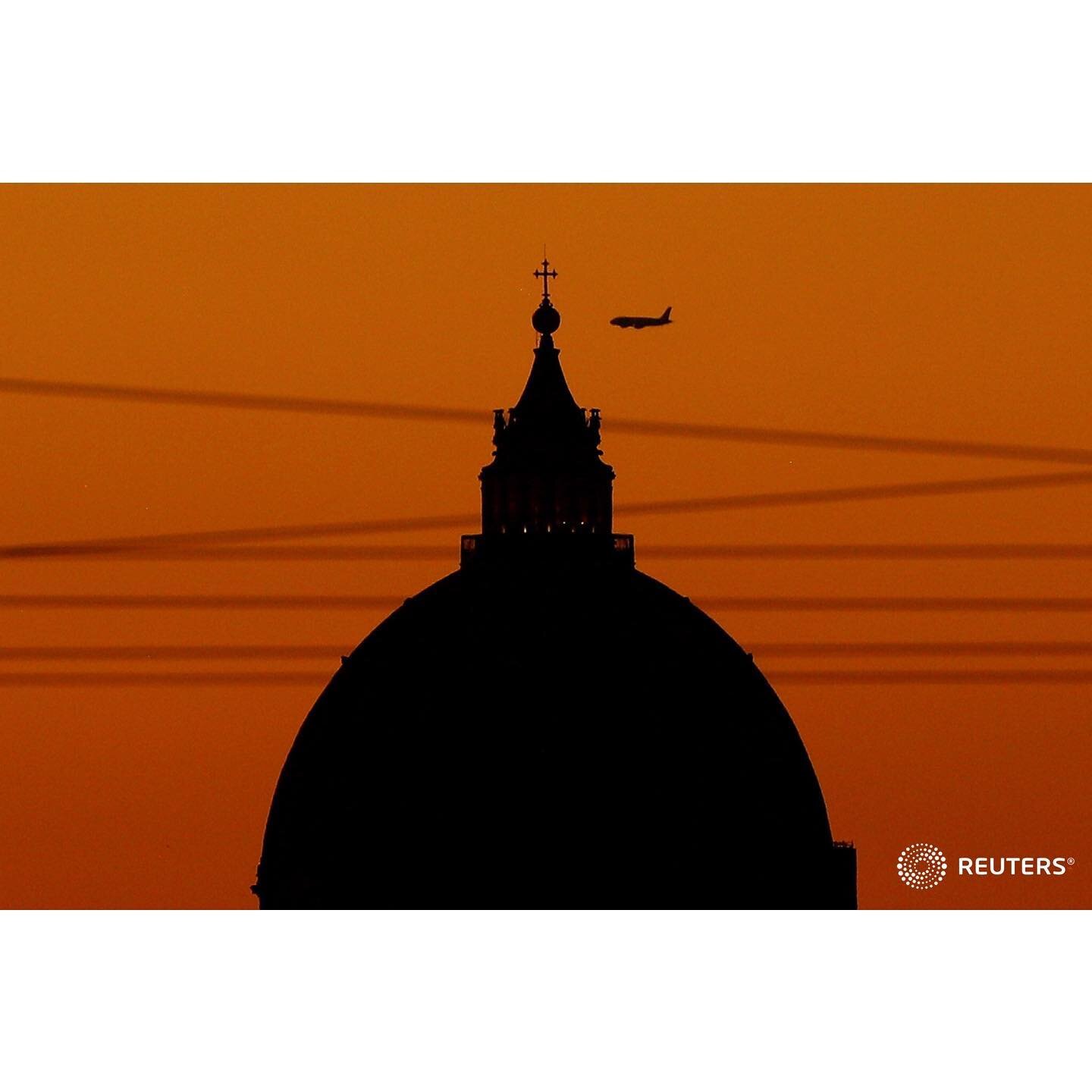 A plane flies across the sky beside the dome of Saint Peter's Basilica during sunset following the outbreak of the coronavirus disease (COVID-19) in Rome, Italy, August 19, 2020. 
.
.
.
.
.
#Italy #Rome #Vatican #St.Peter #SaintPeter #Basilica #Dome 