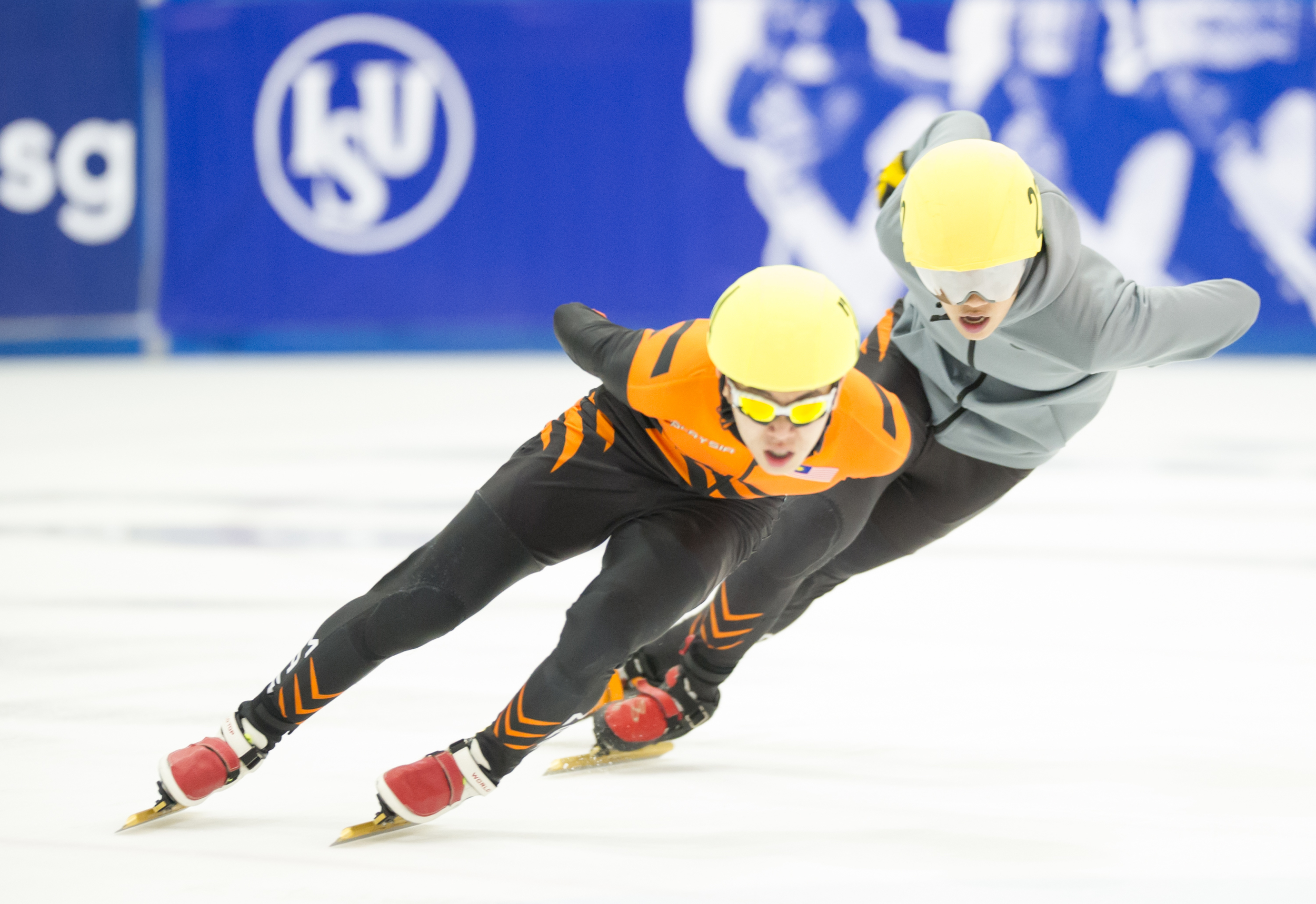 Two Malaysian speed skaters edge on the ice during the Tri-series SEA cup at the Rink.
