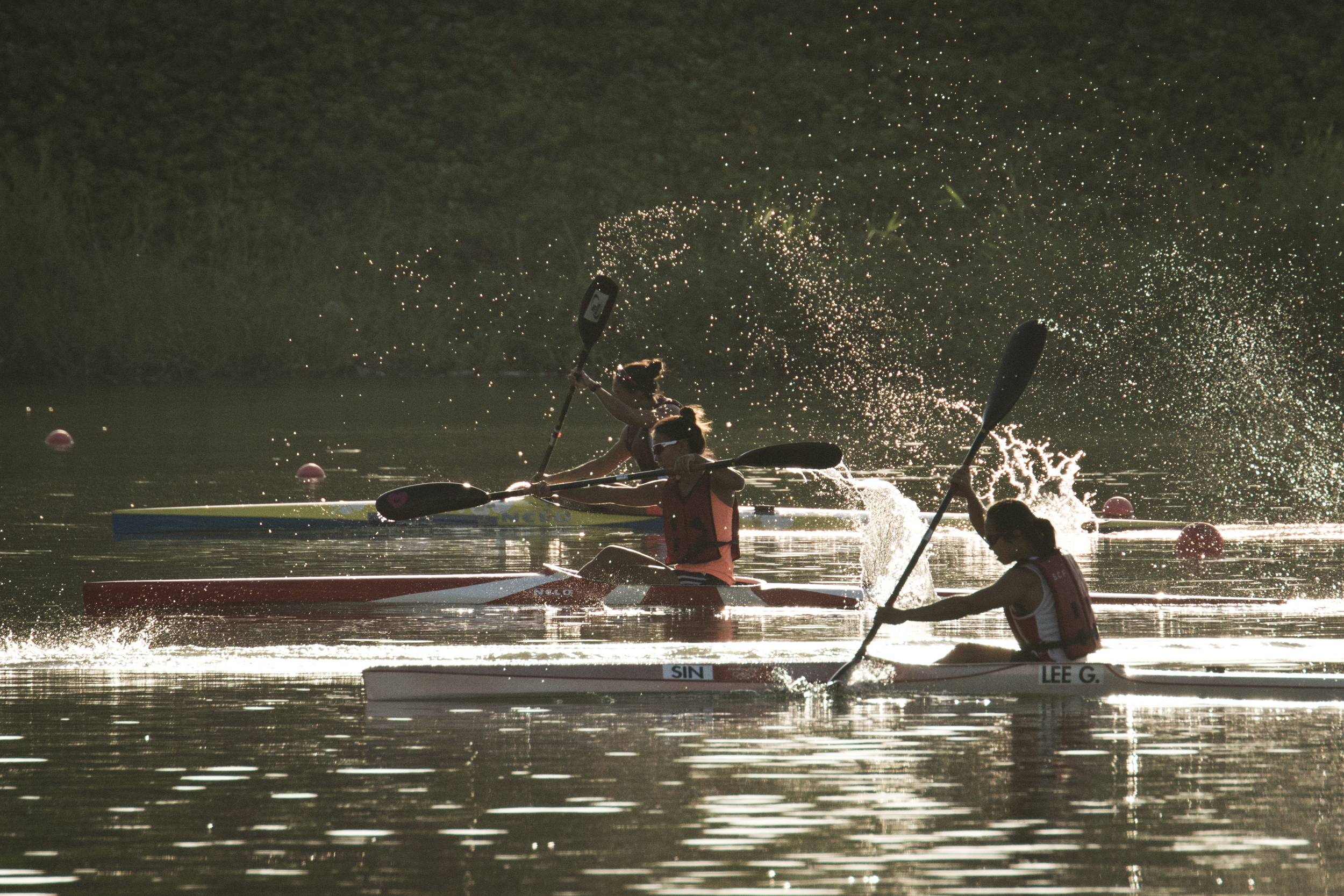 Kayakers paddle in the golden hour at the Marina Channel.