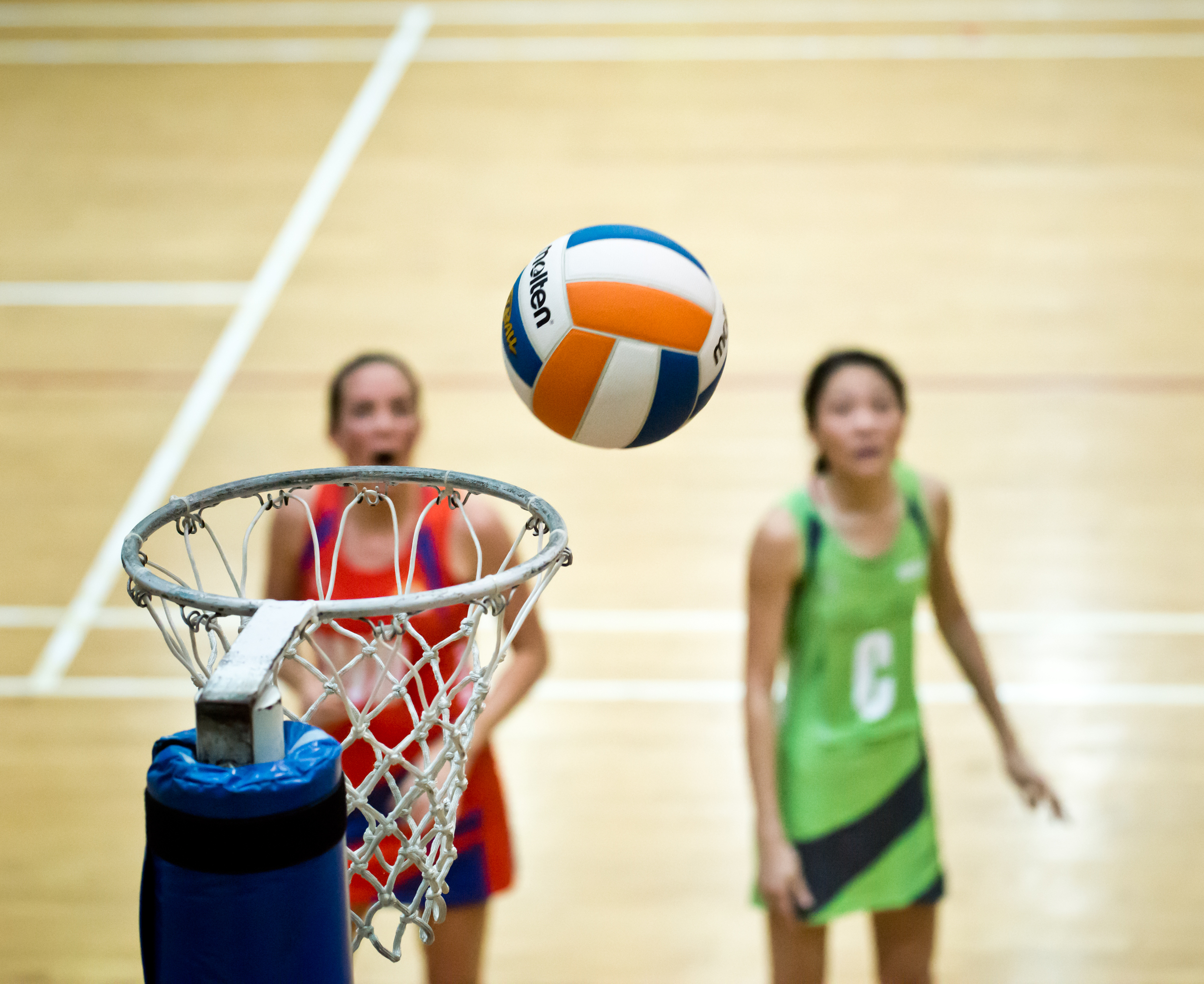 Netballers watch as a ball approaches the net during a Netball Super League match at the Toa Payoh Sports Hall.