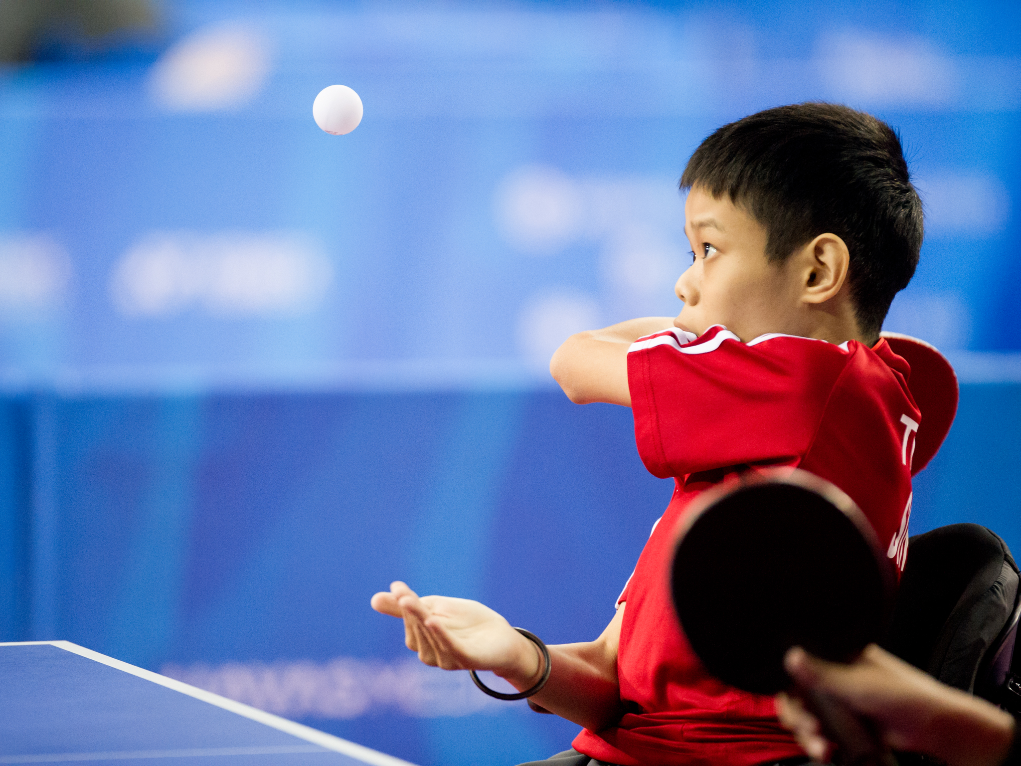 A para-table tennis player serves during the ASEAN Para Games at the OCBC Arena.