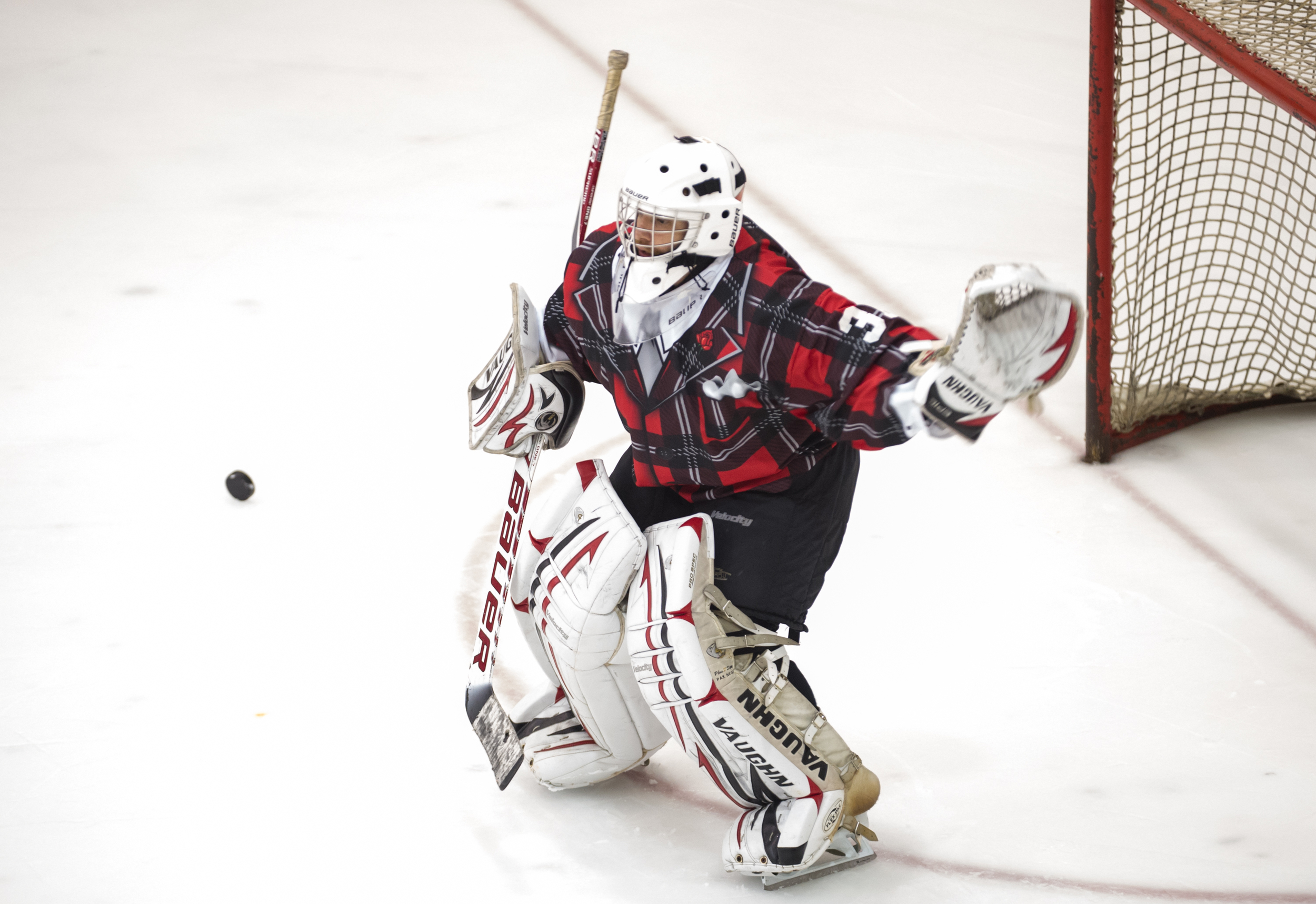 A goal keeper stares at an approaching puck during the Lion City Cup at the Rink.