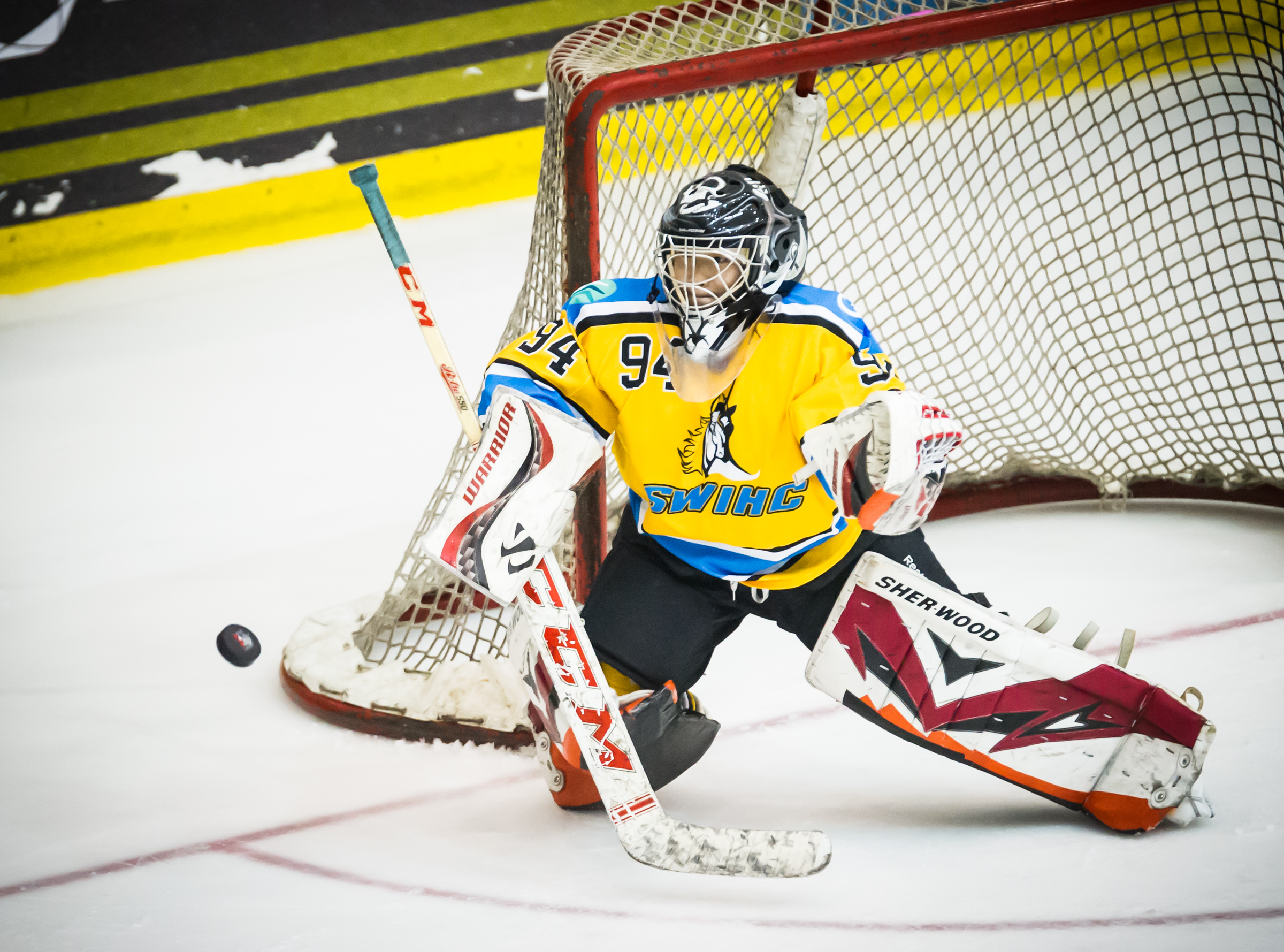 The Singapore Women's Ice Hockey Club goal keeper stares at an approaching puck during the Lion City Cup at the Rink.