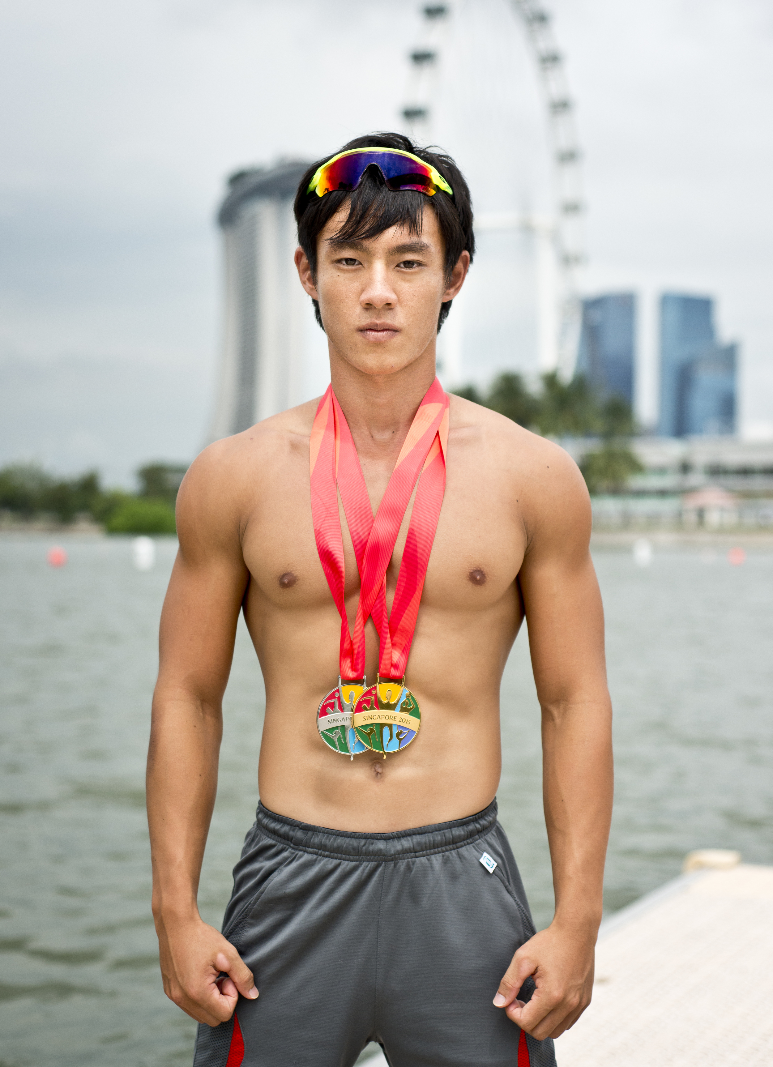 A kayaker poses with some of his SEA Games medals at the Marina Channel.
