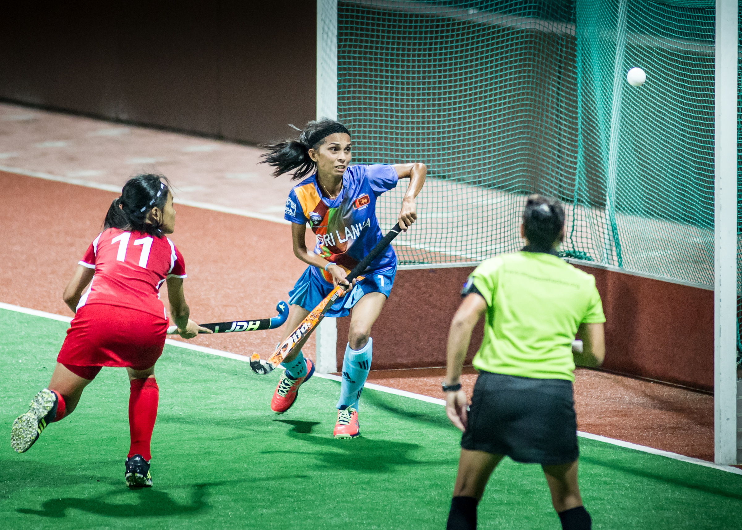 A Singaporean player scores against Sri Lanka during a World Hockey League match at the Sengkang Sports Complex.