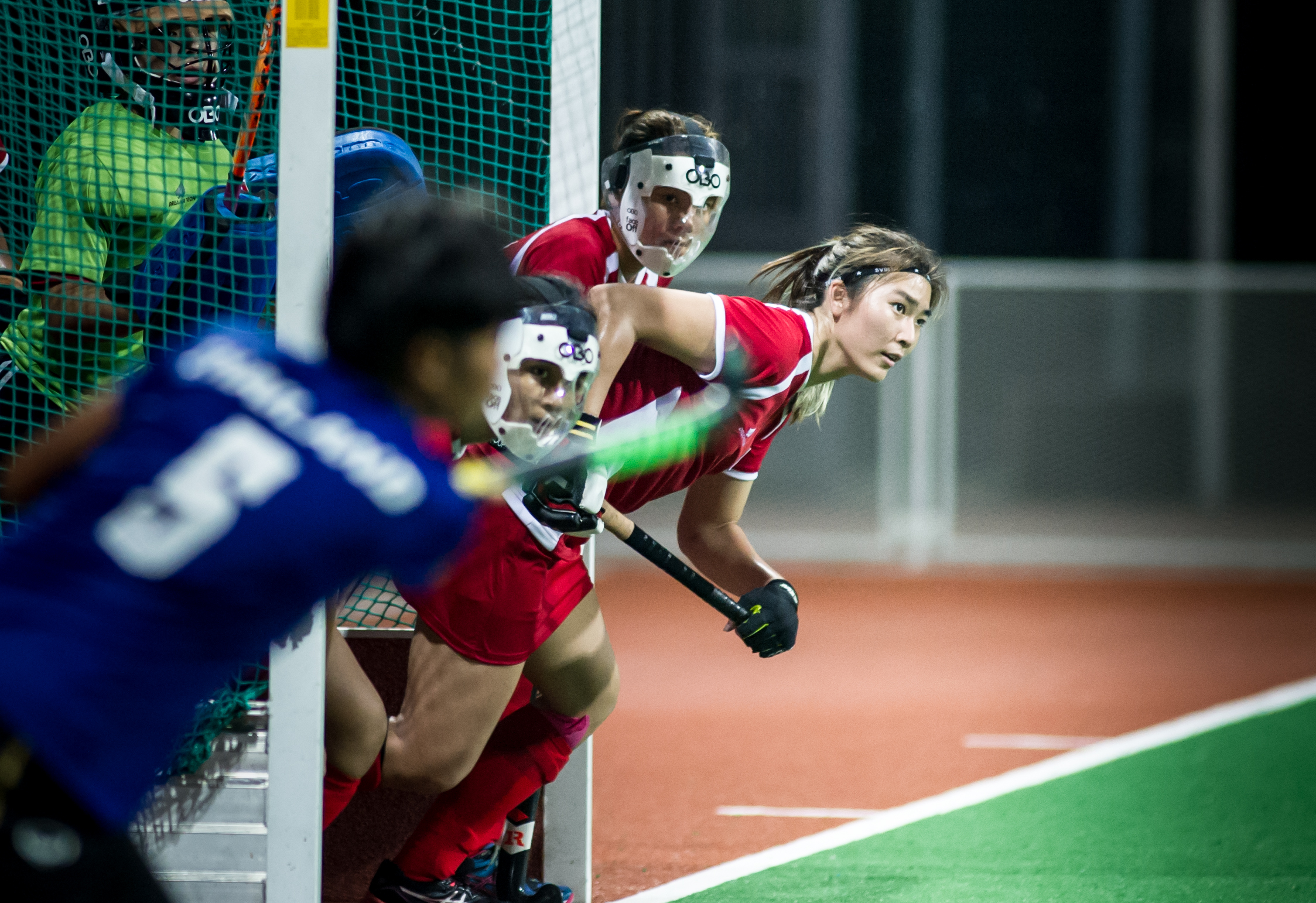 A Singaporean player rushes out of the goal as a Thai player takes a corner penalty during a World Hockey League match at the Sengkang Sports Complex.