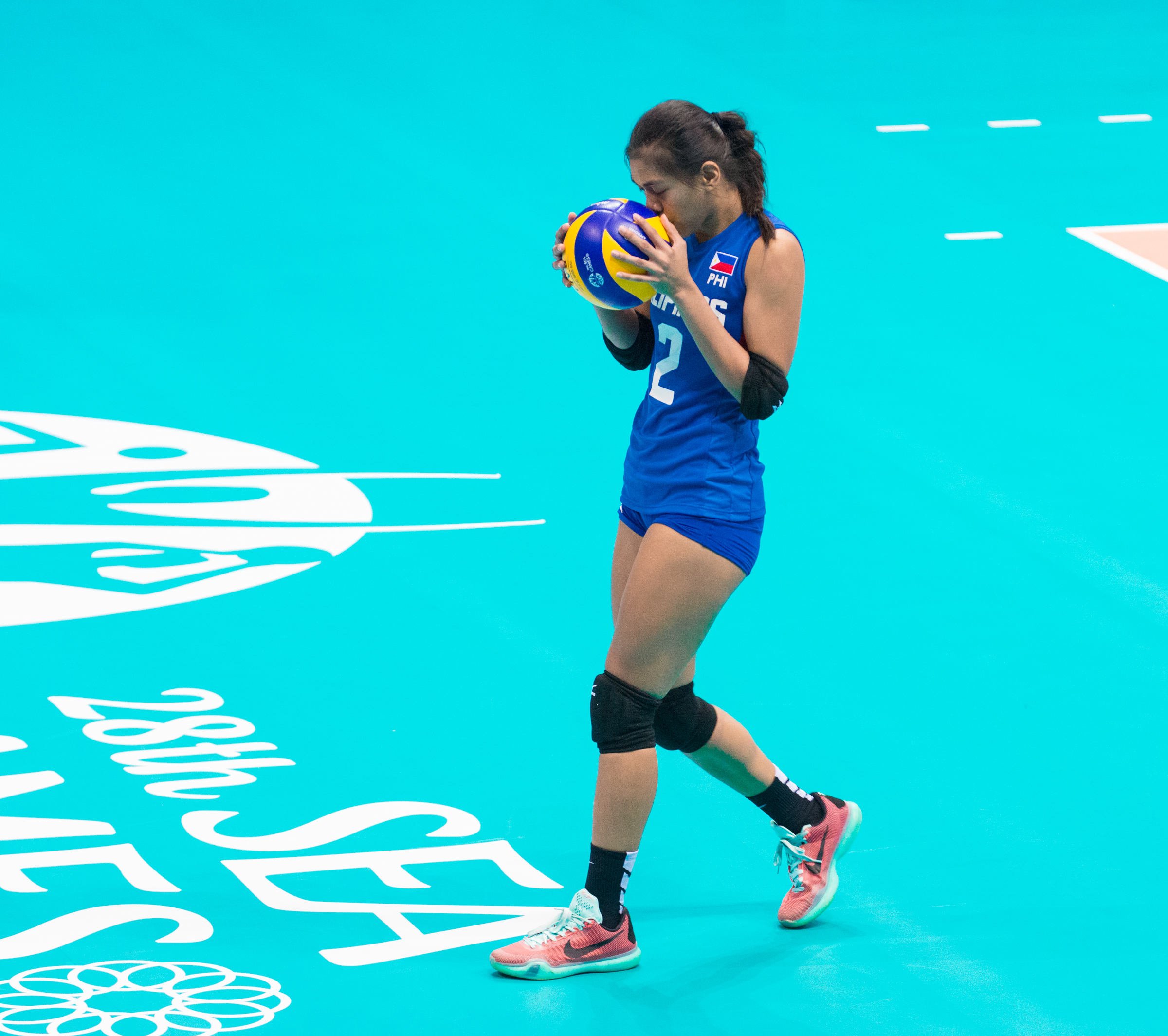 A Filipino player kisses the ball before a service during a match at the OCBC Arena.