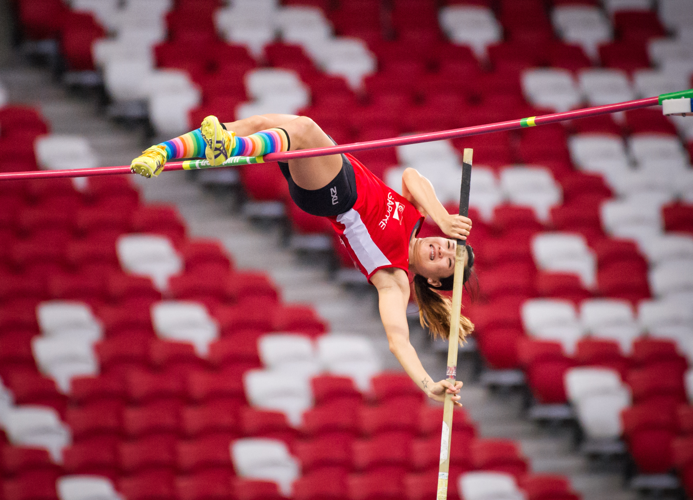 A Singaporean Pole Vaulter prepares to fly over the bar during the Singapore Open Track and Field Championships held at the Singapore Sports Hub.