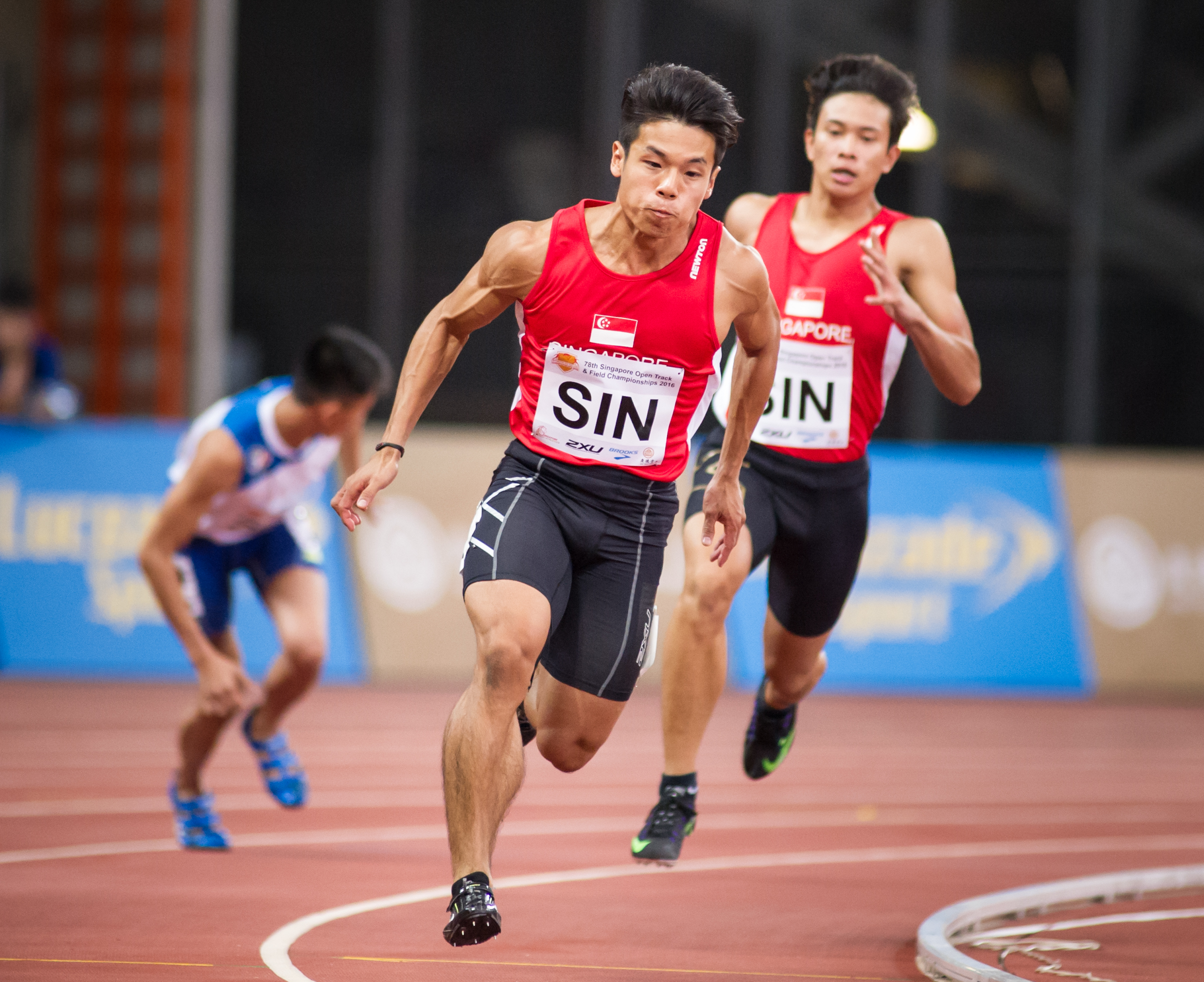 A Singaporean runner prepares to receive the baton during the Singapore Open Track and Field Championships held at the Singapore Sports Hub.
