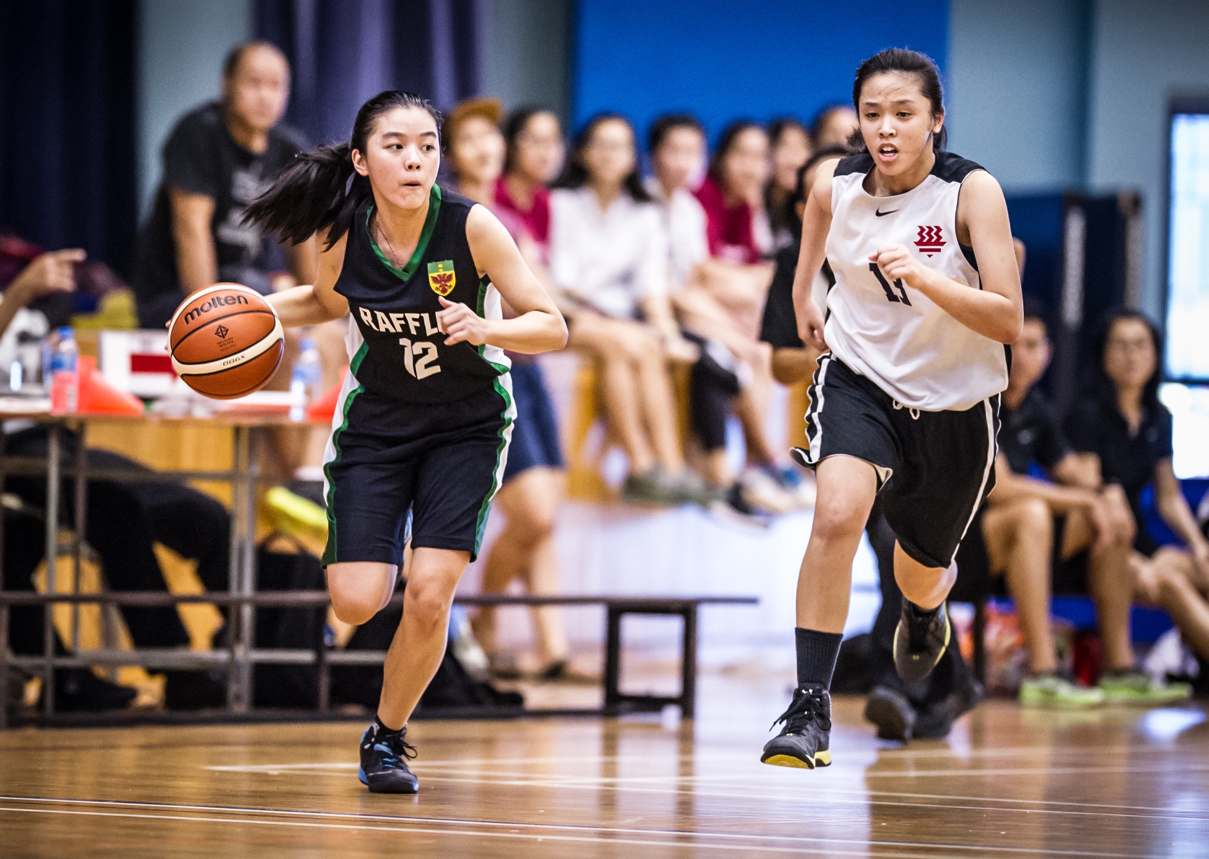 A Basketball player drives with the ball during a National Schools match at the Jurong East Sports Complex.
