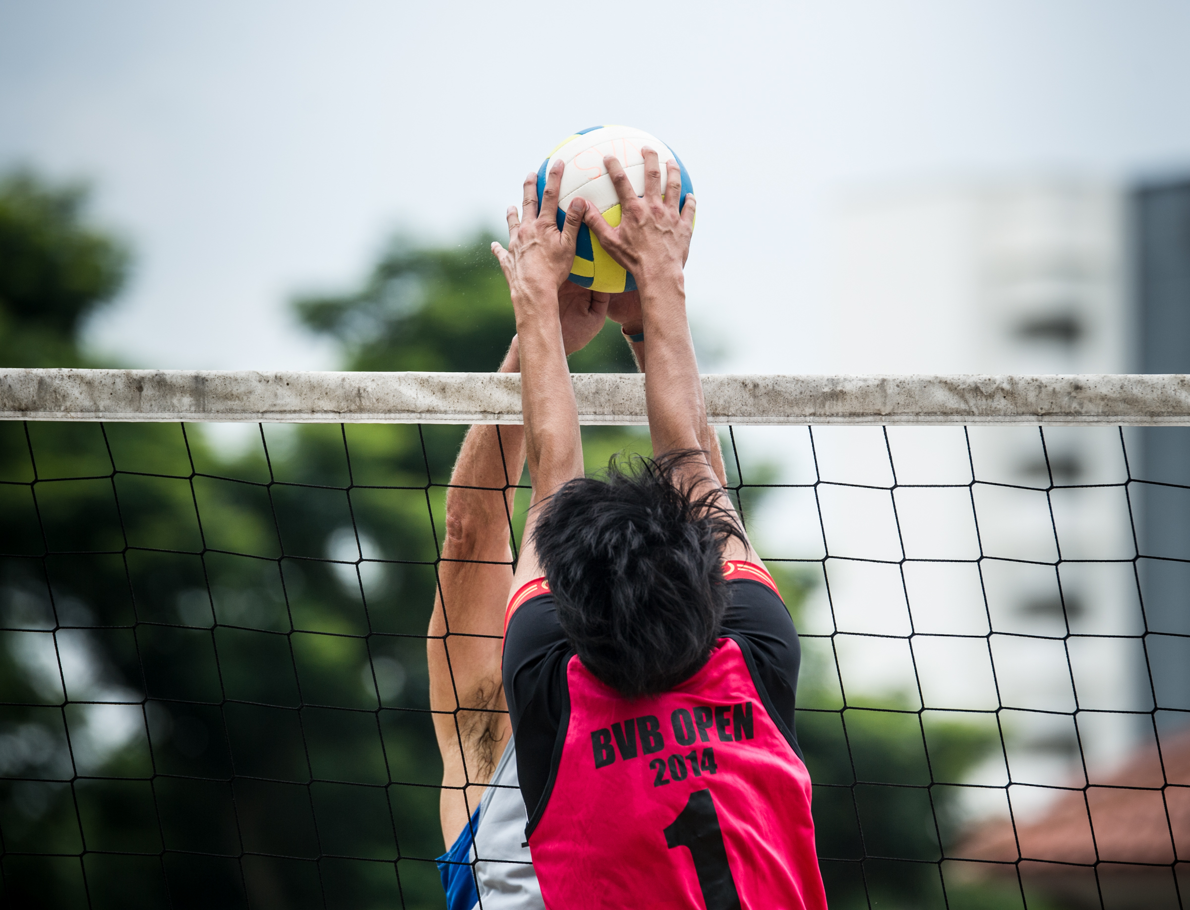 A Hong Kong player prepares to block a spike during the Beach Volleyball National Series at the Yio Chu Kang Swimming Complex.