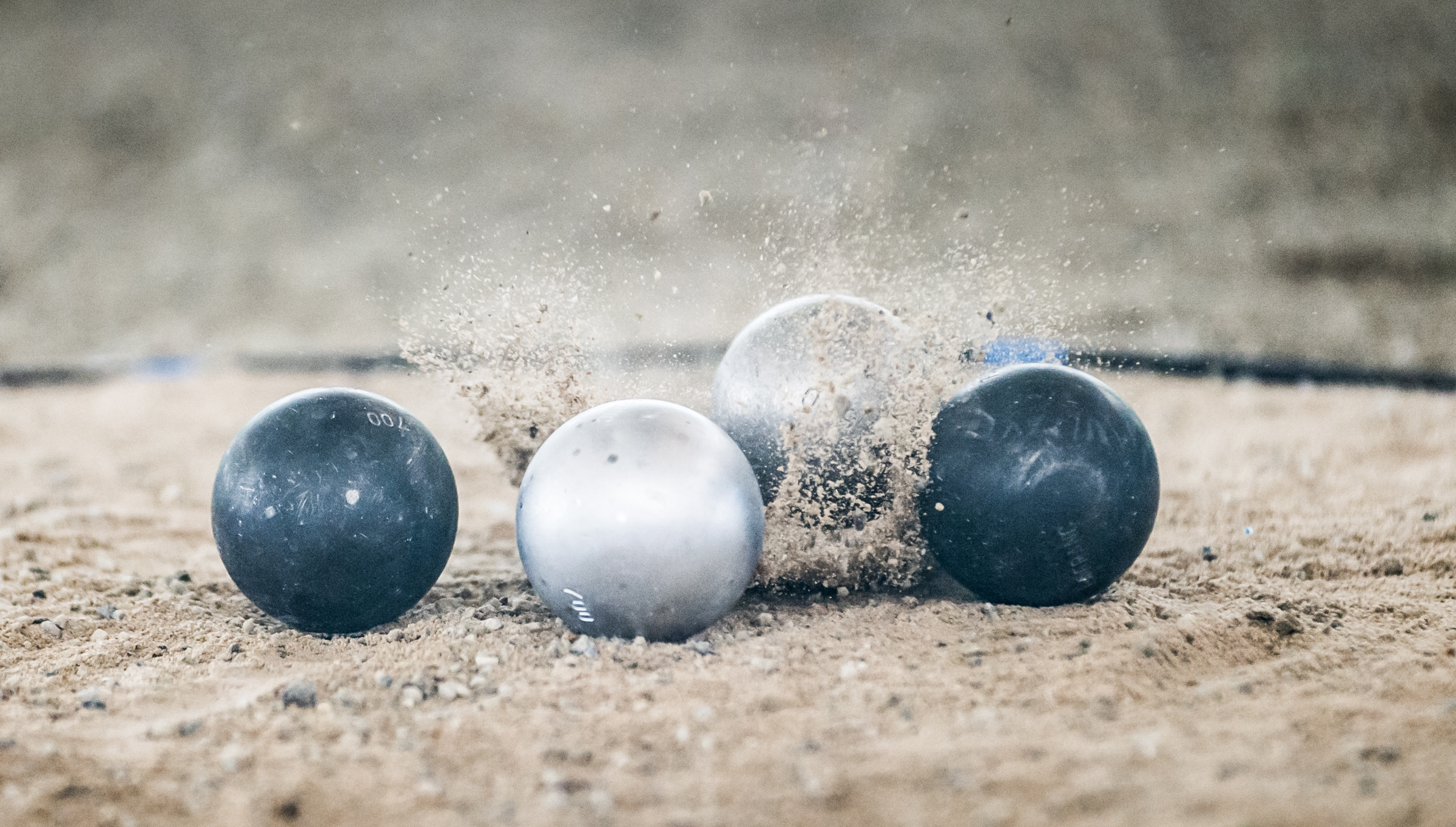 Petanque balls collide during the ASEAN University Games at the Toa Payoh Sports Complex.