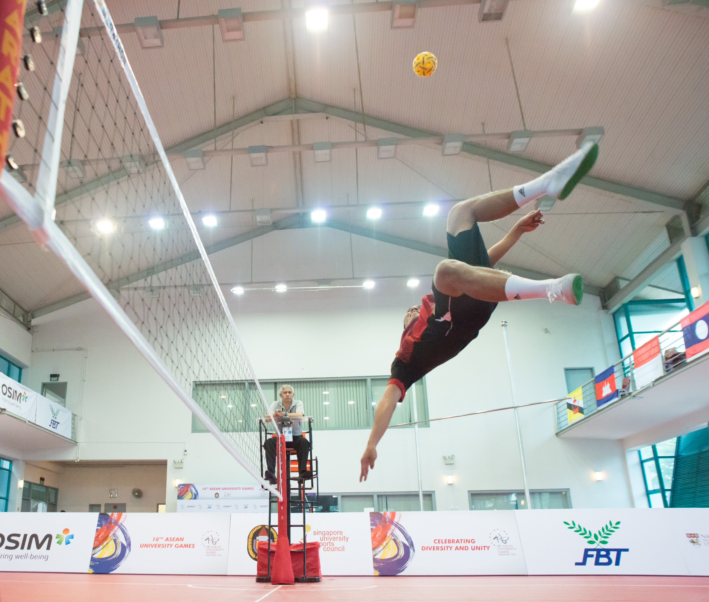 A Malaysian player prepares to kick the ball during the sepak takraw competition of the ASEAN University Games at the Bedok Sports Hall.