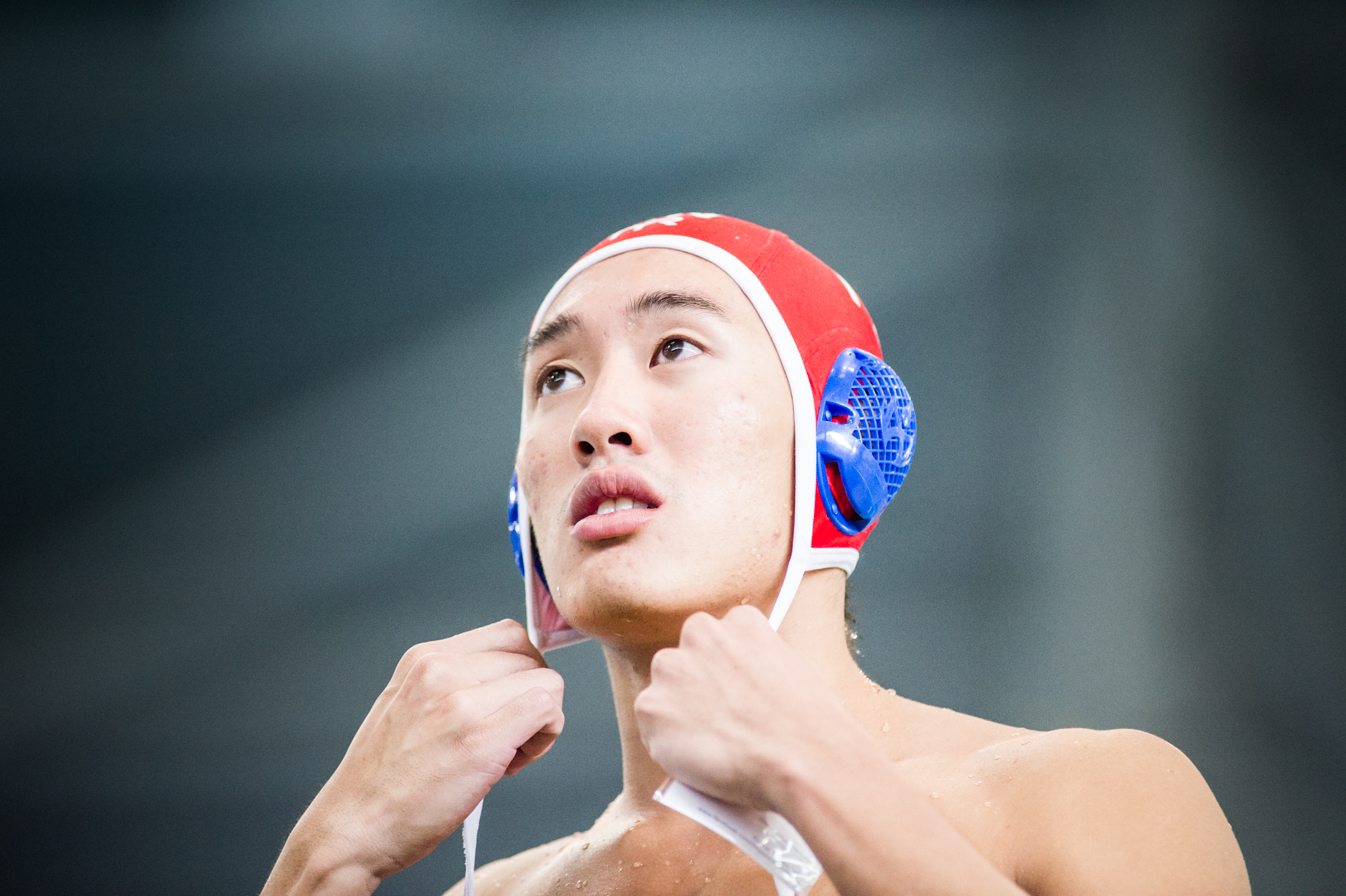 A Singaporean player puts on his cap before the water polo competition of the ASEAN University Games at the OCBC Aquatic Centre.
