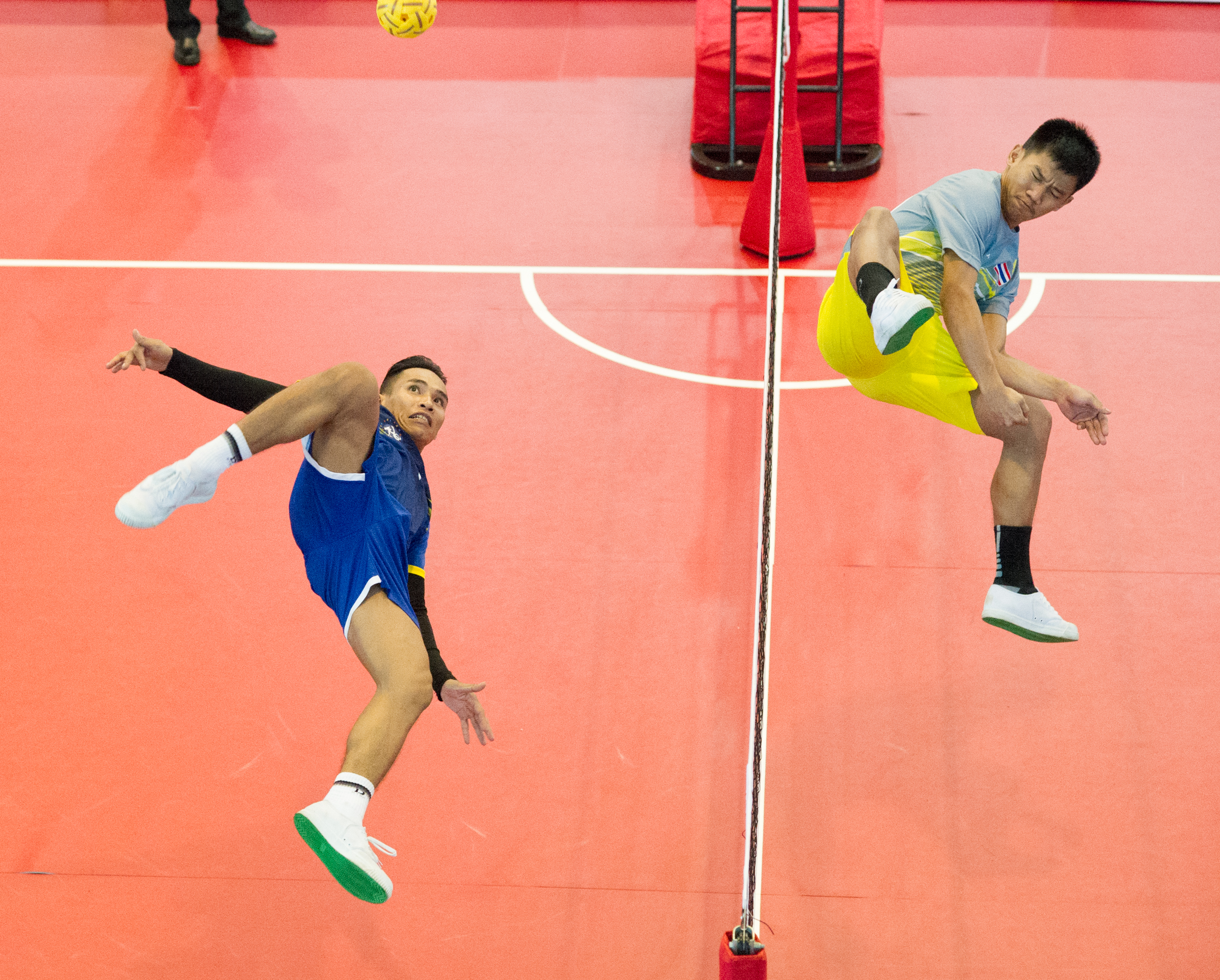 A Laotian player prepares to spike during the sepak takraw competition of the ASEAN University Games at the Bedok Sports Hall.