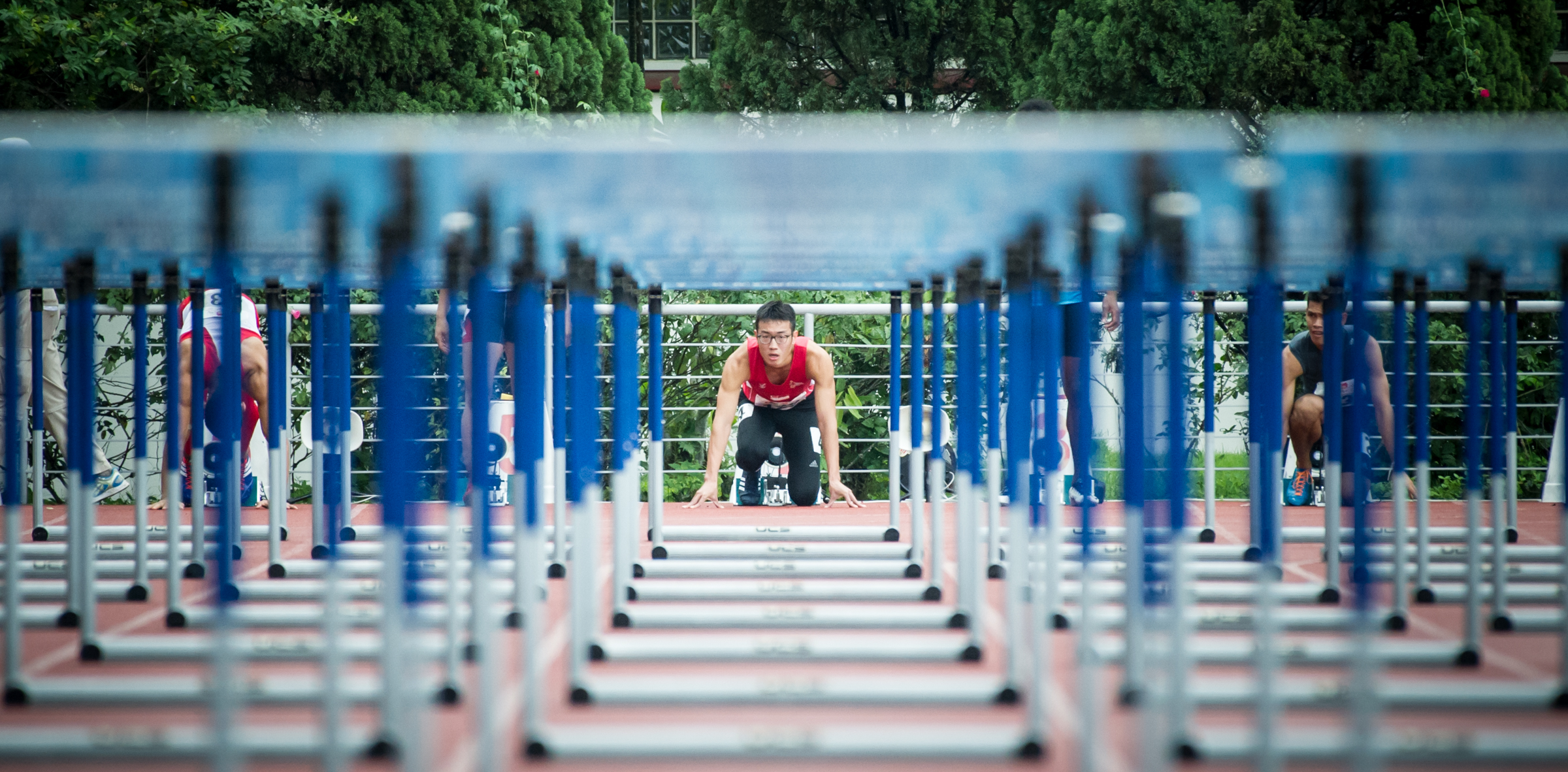 A Singaporean hurdler looks through the hurdles during the 110m hurldes competition of the ASEAN University Games at the Chua Chu Kang Stadium.