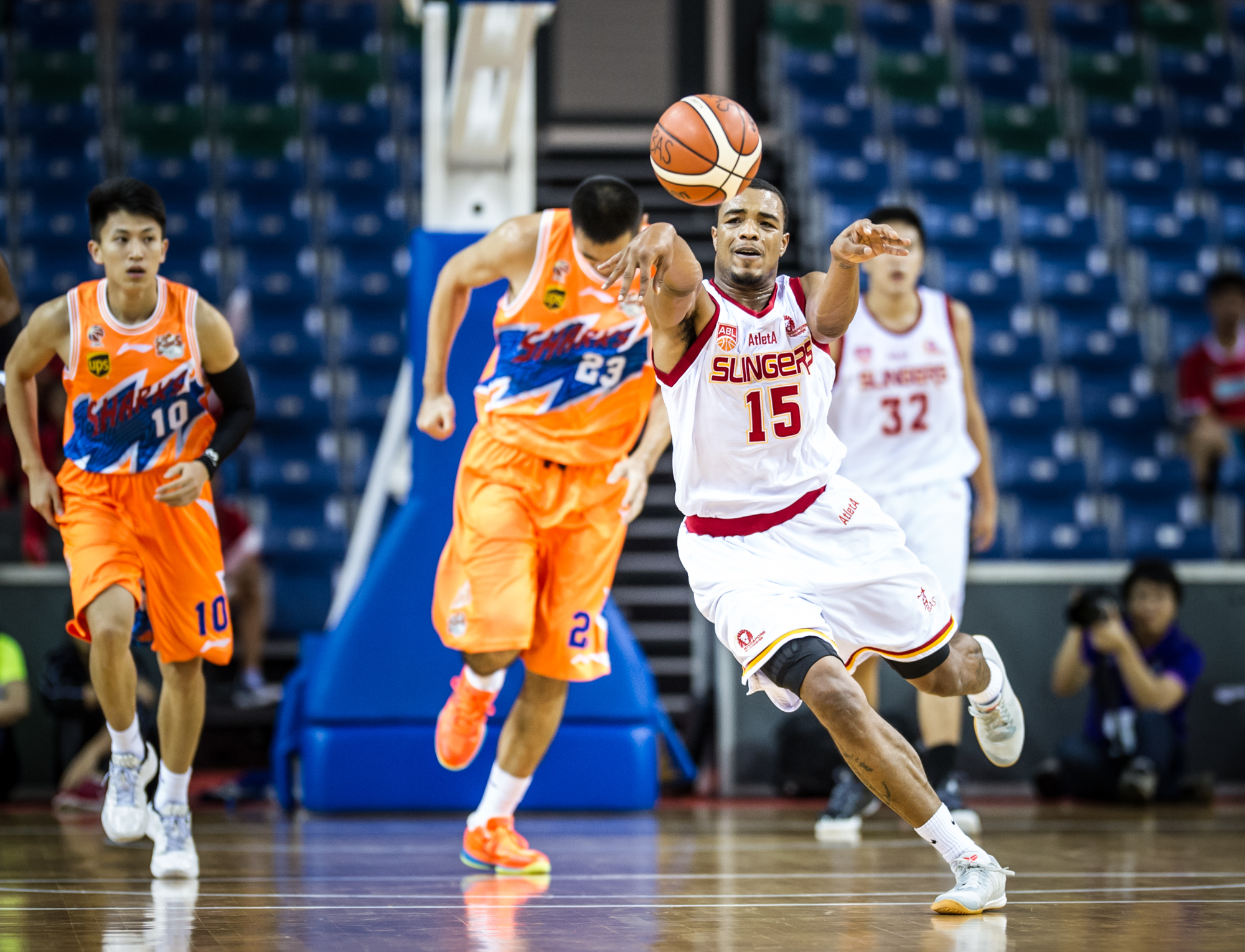 A Singapore Basketball player passes the ball during the Merlion Cup basketball competition at the OCBC Arena.