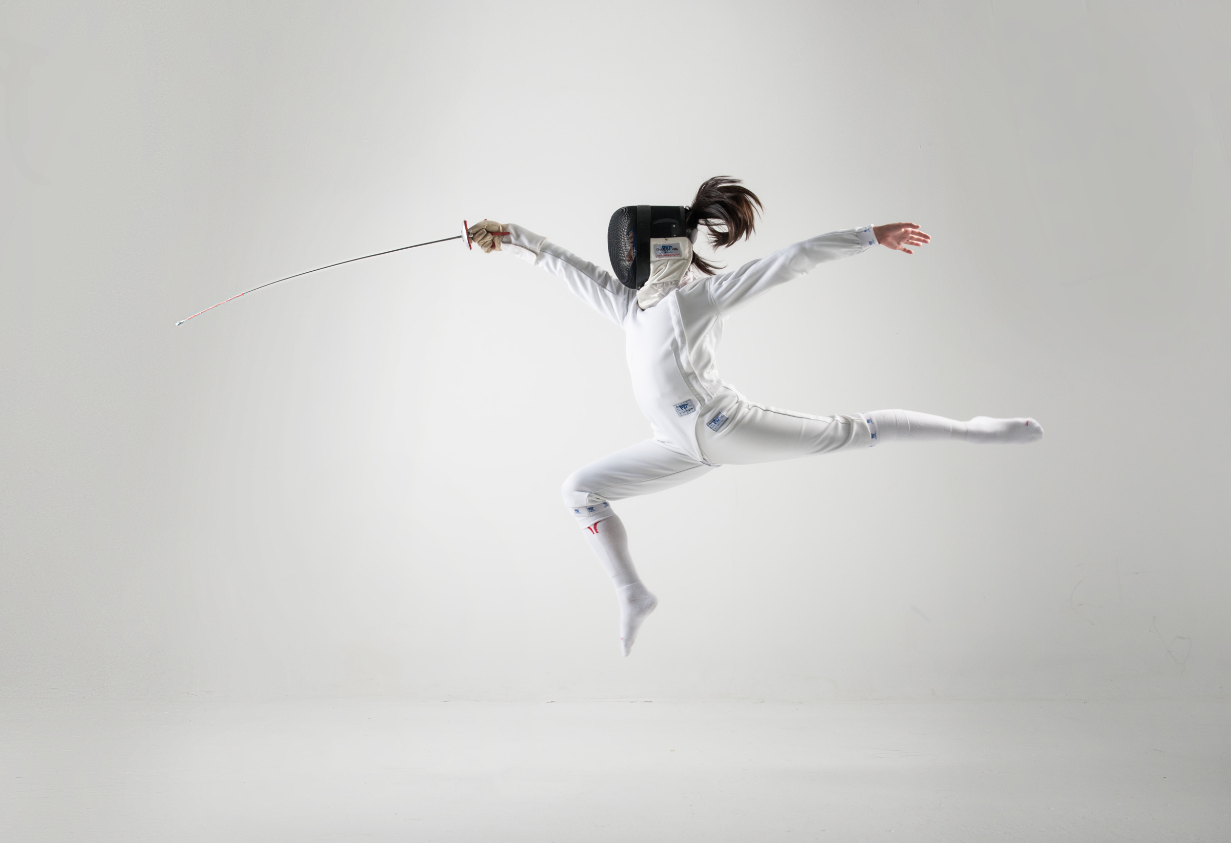 A fencer lunges in the Studio.
