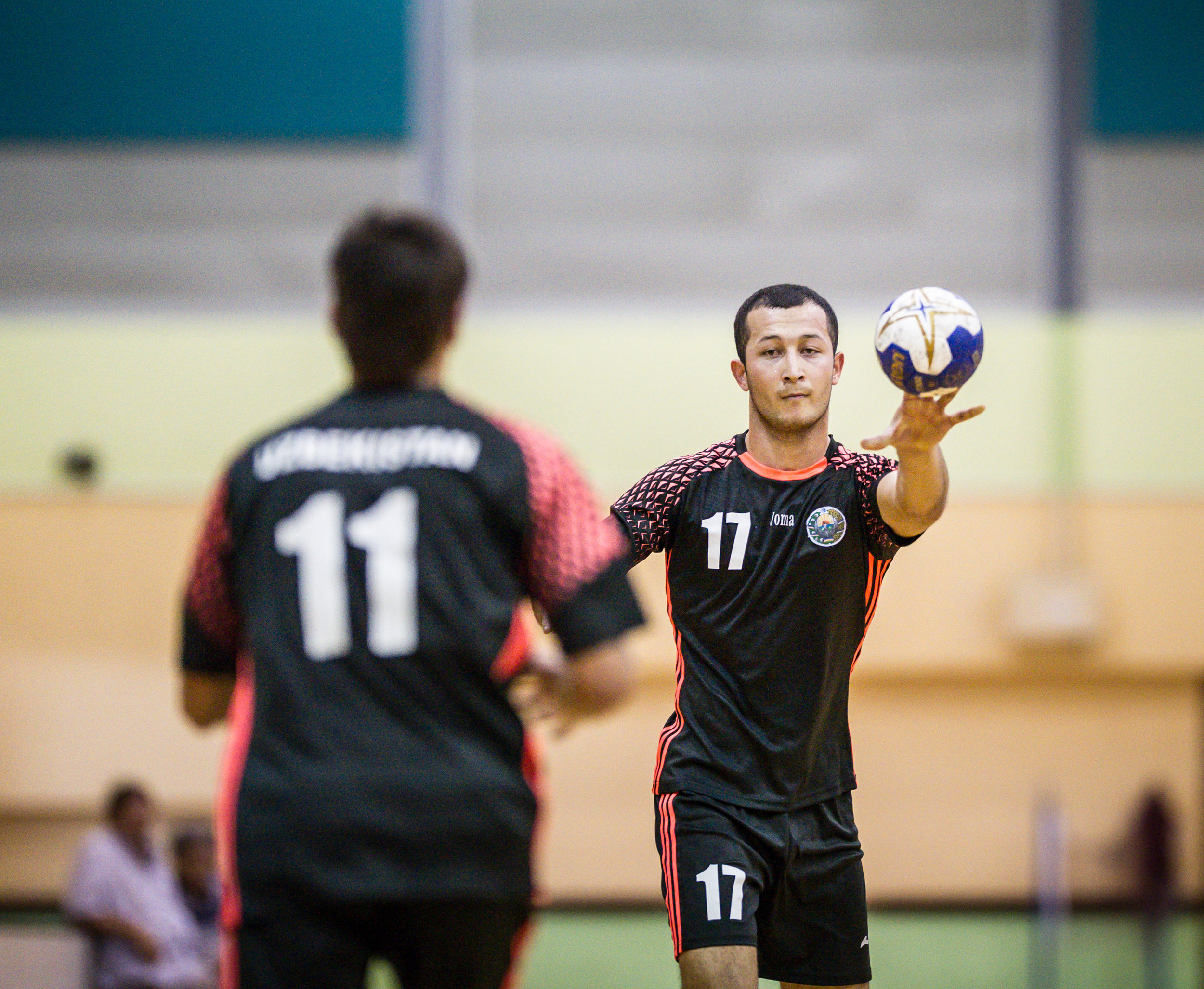 An Uzbek player passes the ball to a team mate during an International hand ball match at the Sengkang Sports Complex.