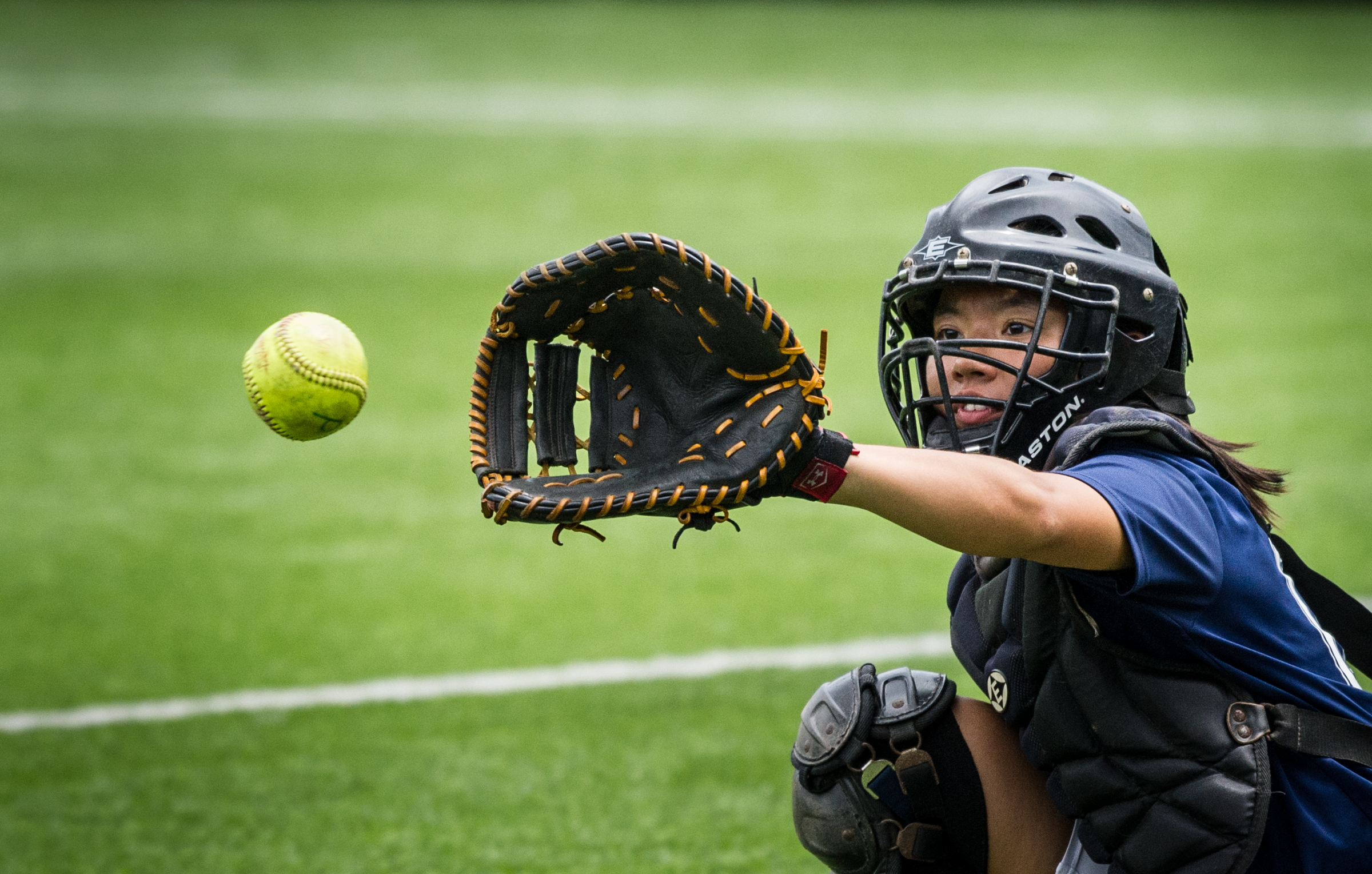 A Singaporean player prepares to catch the ball during the ORA Gryphon Cup slow pitch tournament at Raffles Institution.