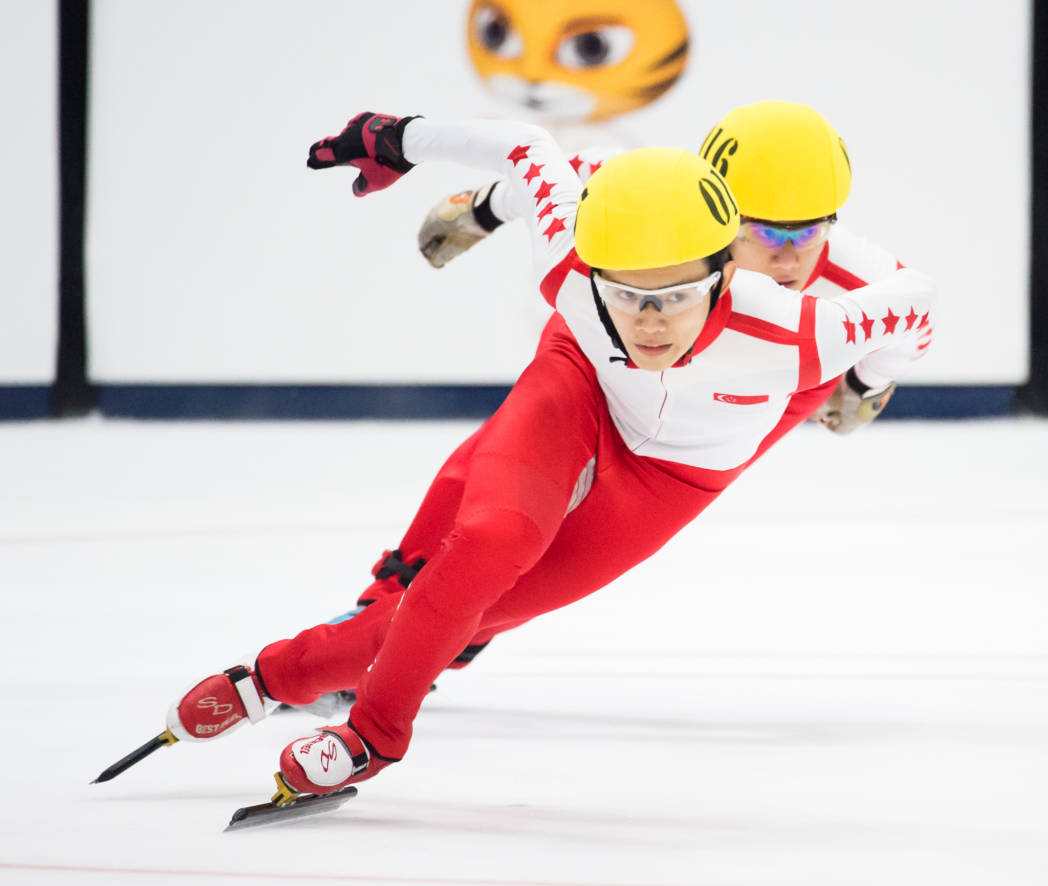 Two Singaporean speed skaters in action during the SEA Games at the Empire City Skating Rink.