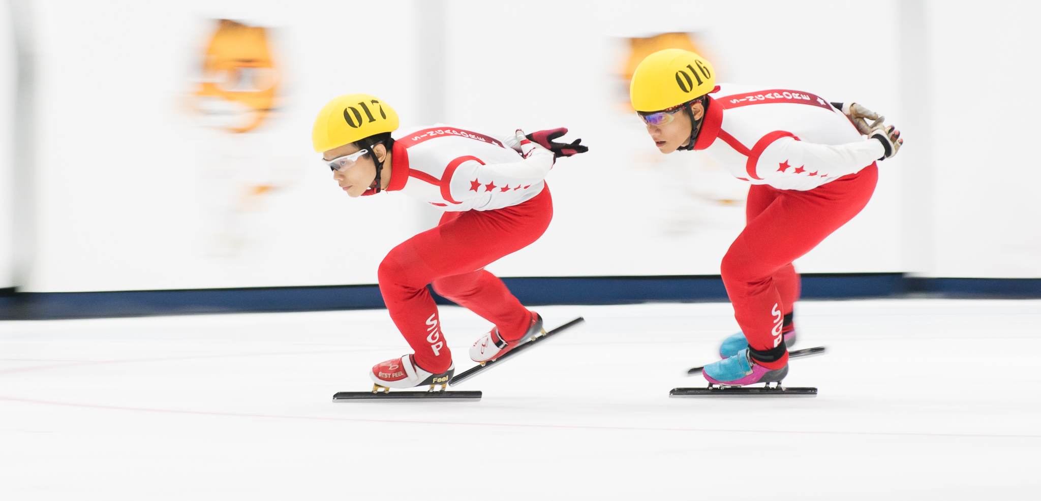 Two Singaporean speed skaters in action during the SEA Games at the Empire City Skating Rink.