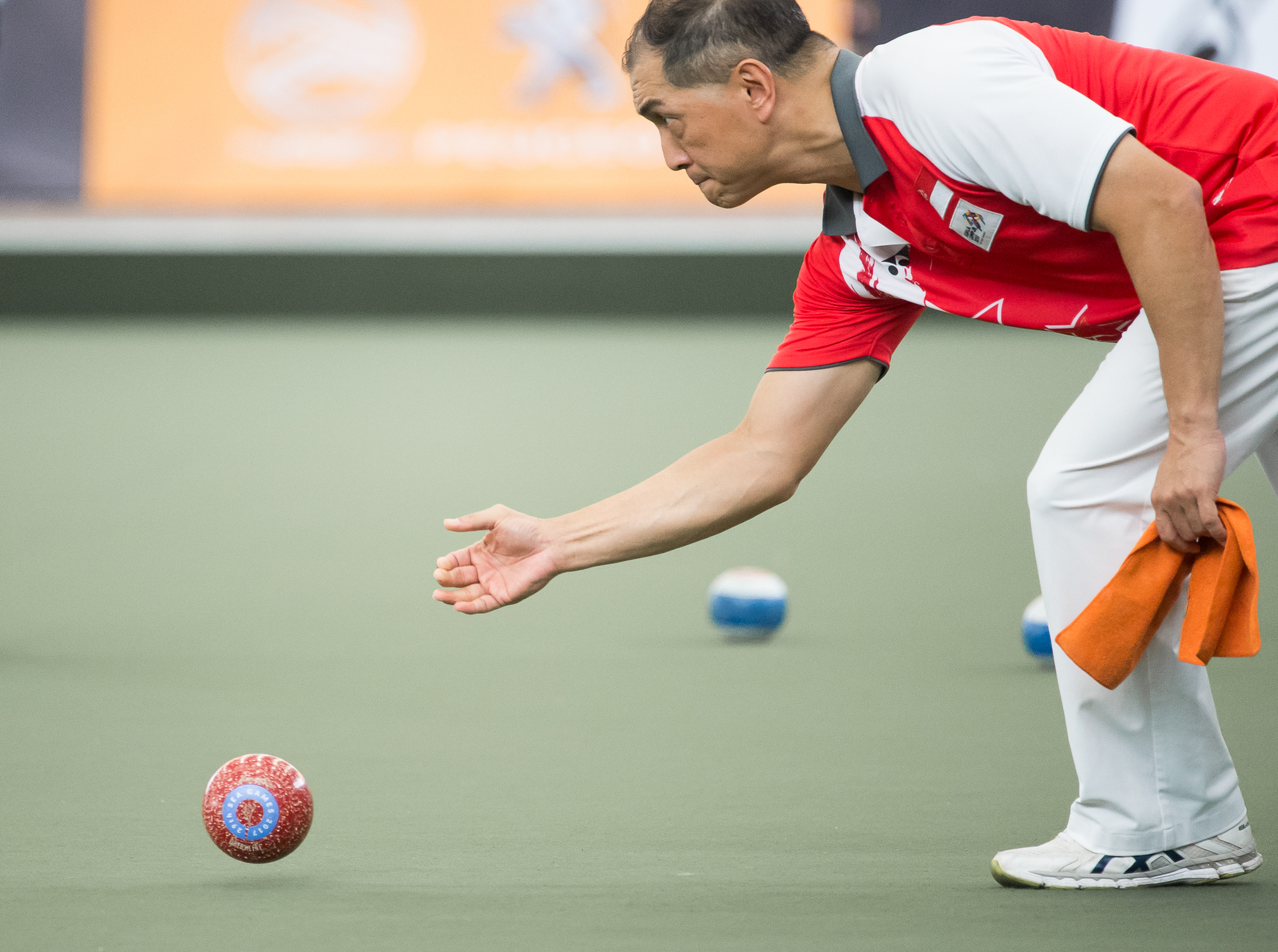 A Singaporean Lawn Bowler in action during the SEA Games at the National Lawn Bowls Centre. 