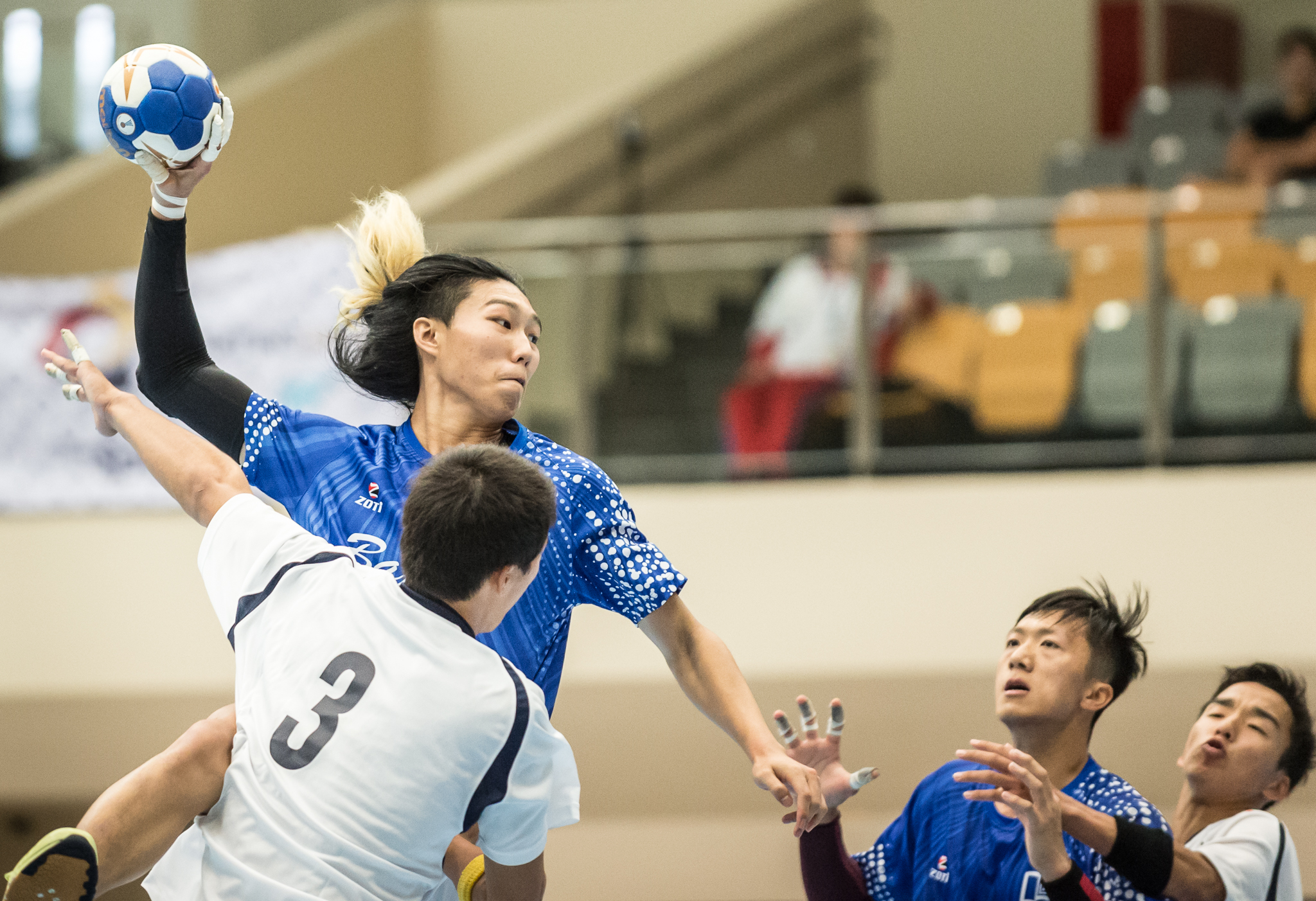 A Hong Kong player prepares to score during an international hand ball match at Our Tampines Hub.