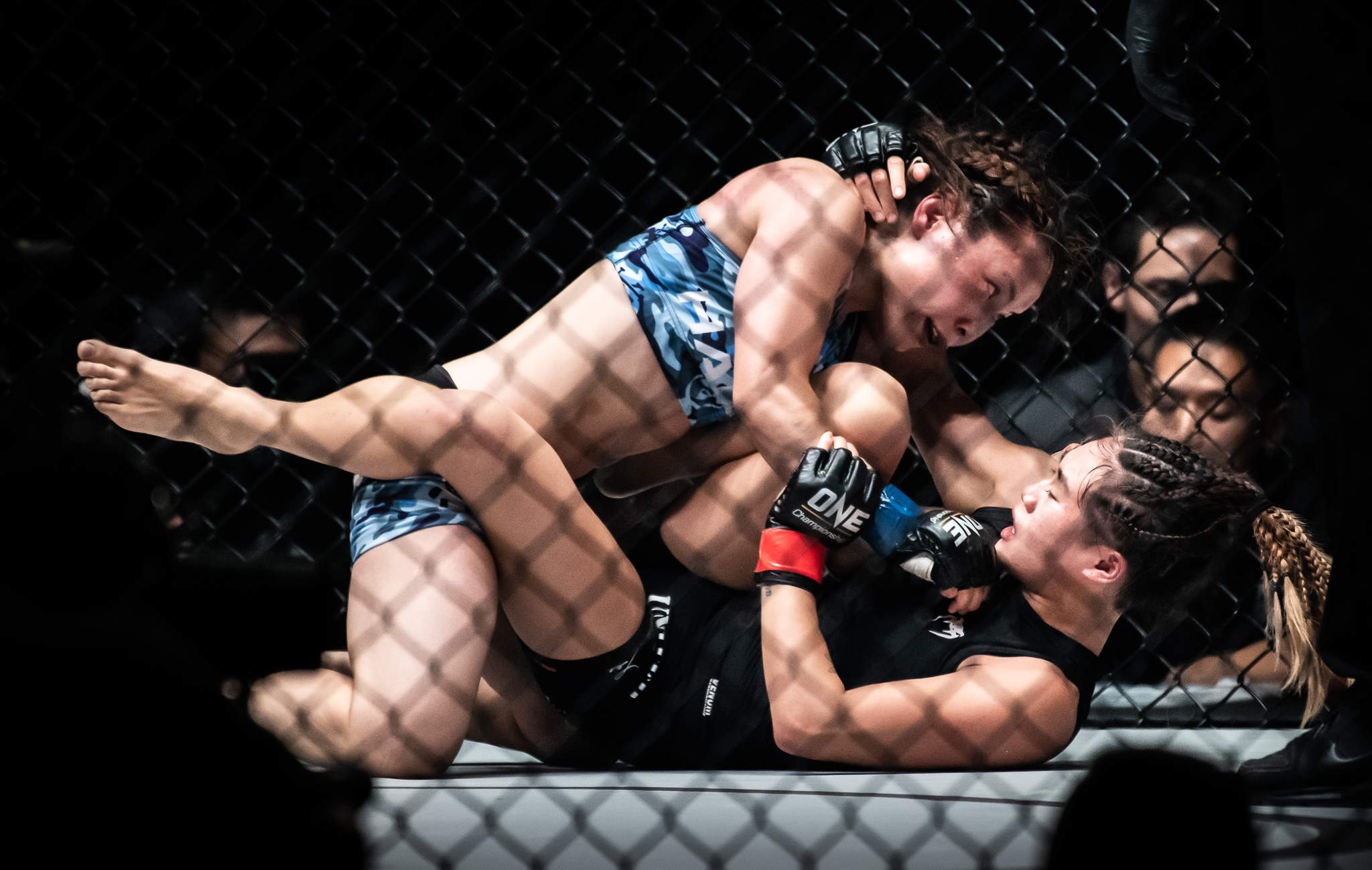 A Japanese and Singaporean opponent during a One Championship World Title match at the Singapore Indoor Stadium.