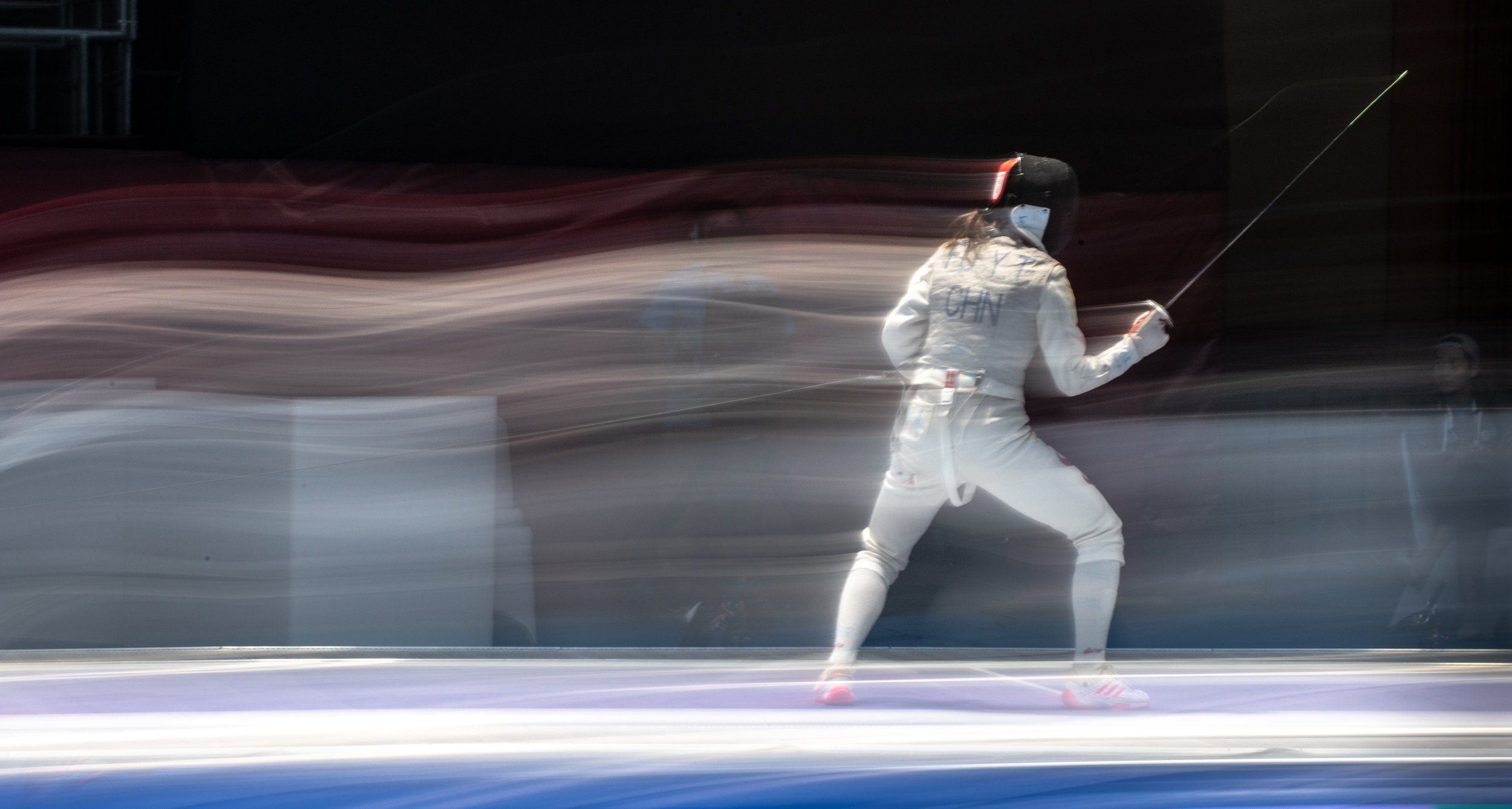 A Chinese fencer in action during the foil team finals of the Asian Games at the Jakarta Convention Centre.