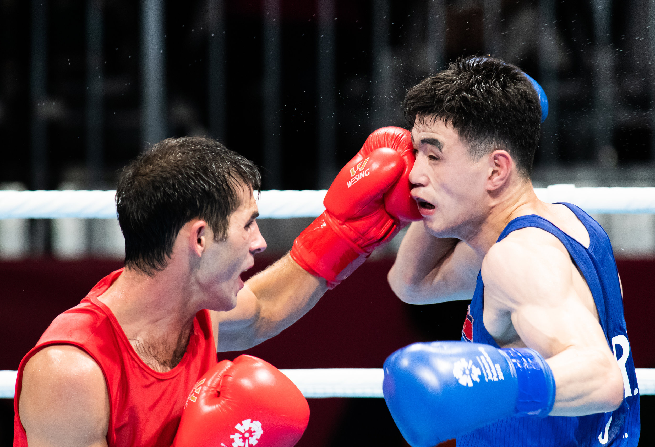 A Turkmenistan boxer punches his North Korean opponent during the Bantam Weight match of the Asian Games at the Jakarta International Expo.