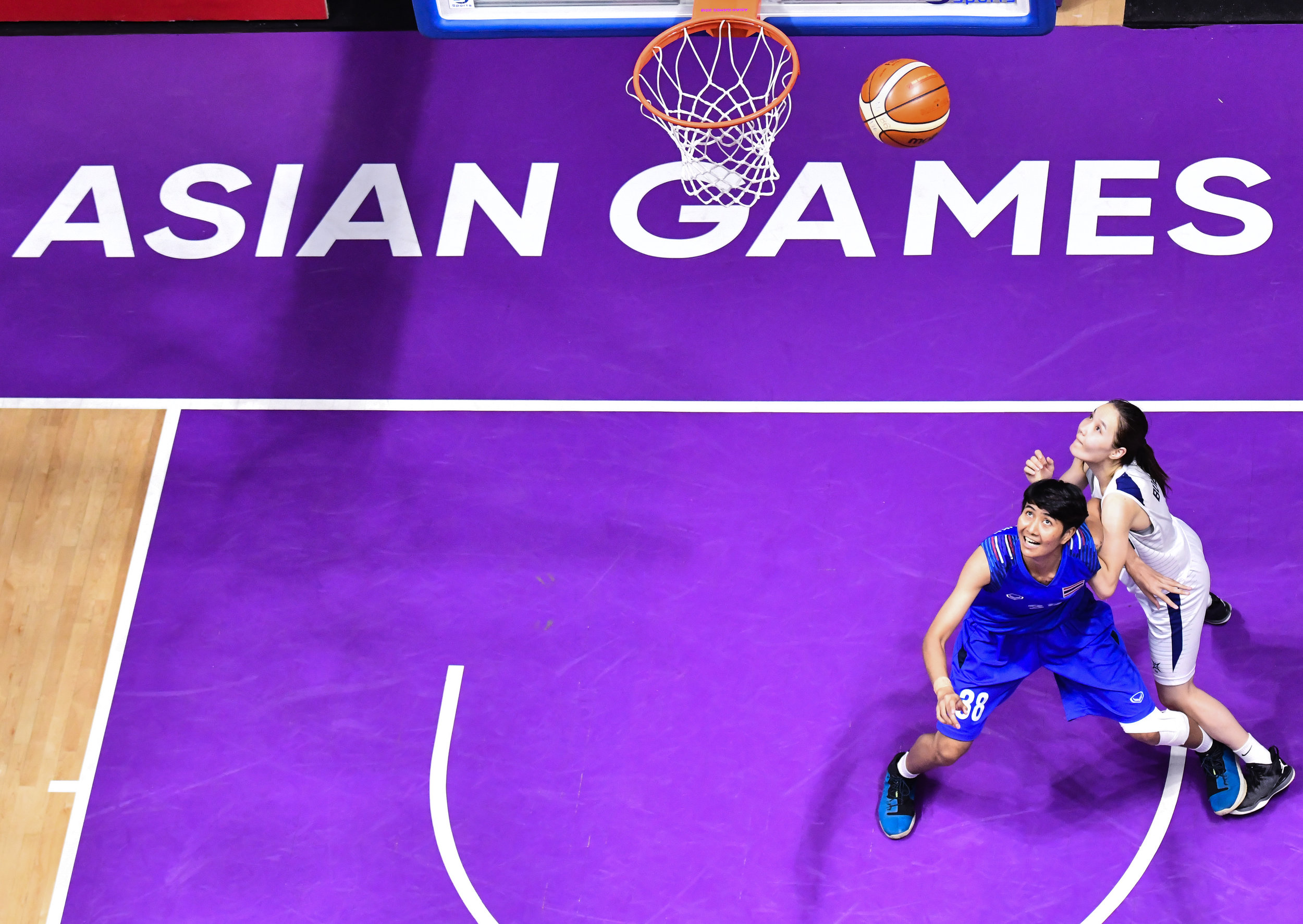 Thai and Mongolian players watch the ball rebound during a match of the Asian Games at the Gelora Bung Karno Sports Complex.