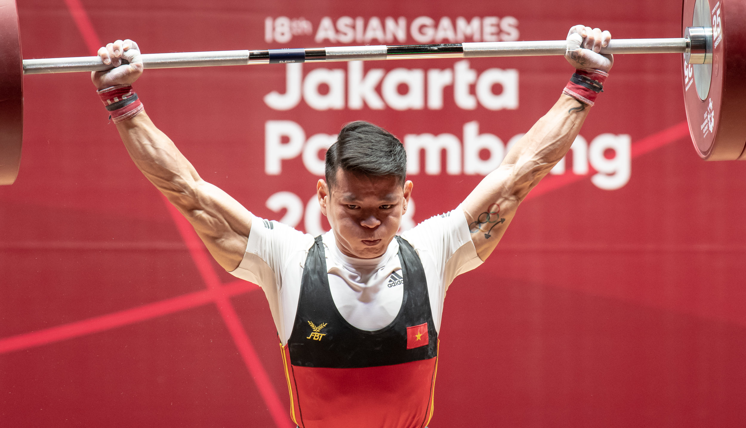 A Vietnamese weightlifter during the men's 56kg event of the Asian Games at the Jakarta International Expo.