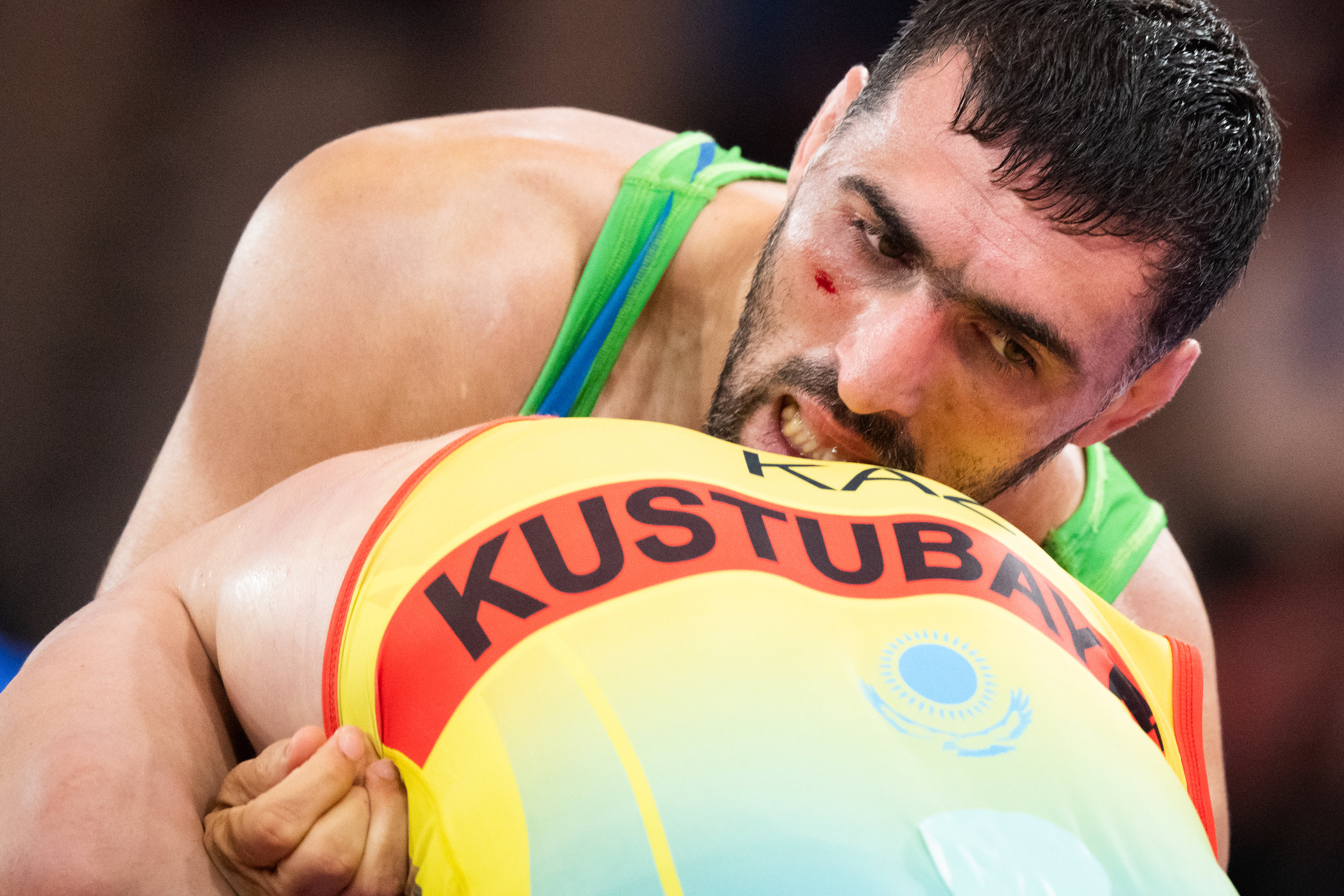 A Uzbek wrestler in action against his Kazakh opponent during his Greco Roman 87 kg match of the Asian Games at the Jakarta Convention Centre.