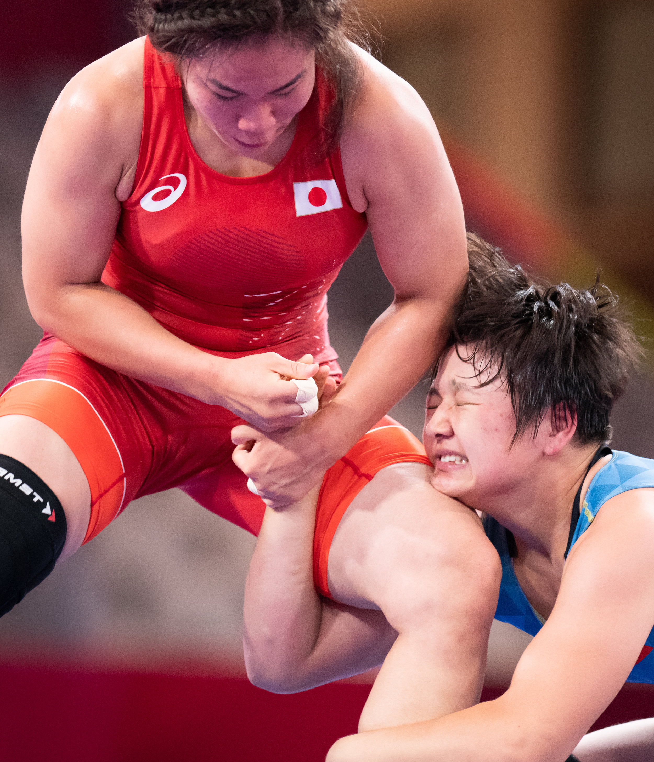 Japanese and Kyrgyz wrestlers in action during the women's freestyle 68kg bronze medal match of the Asian Games at the Jakarta Convention Centre.