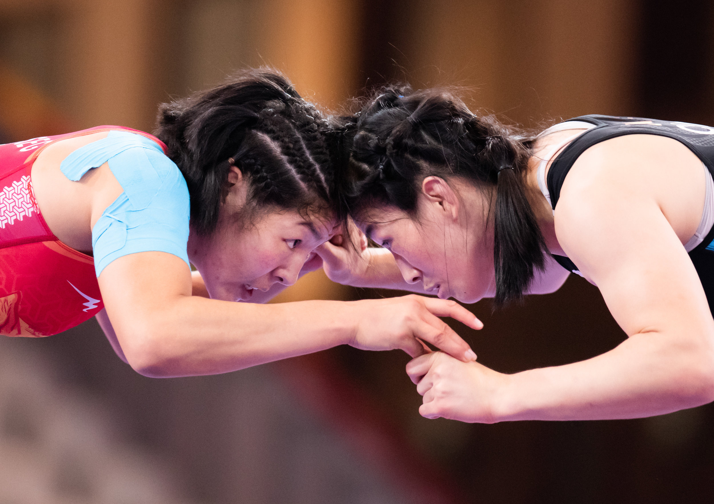 Chinese and Mongolian wrestlers face off during the women's 68kg freestyle finals of the Asian Games  at the Jakarta Convention Centre.