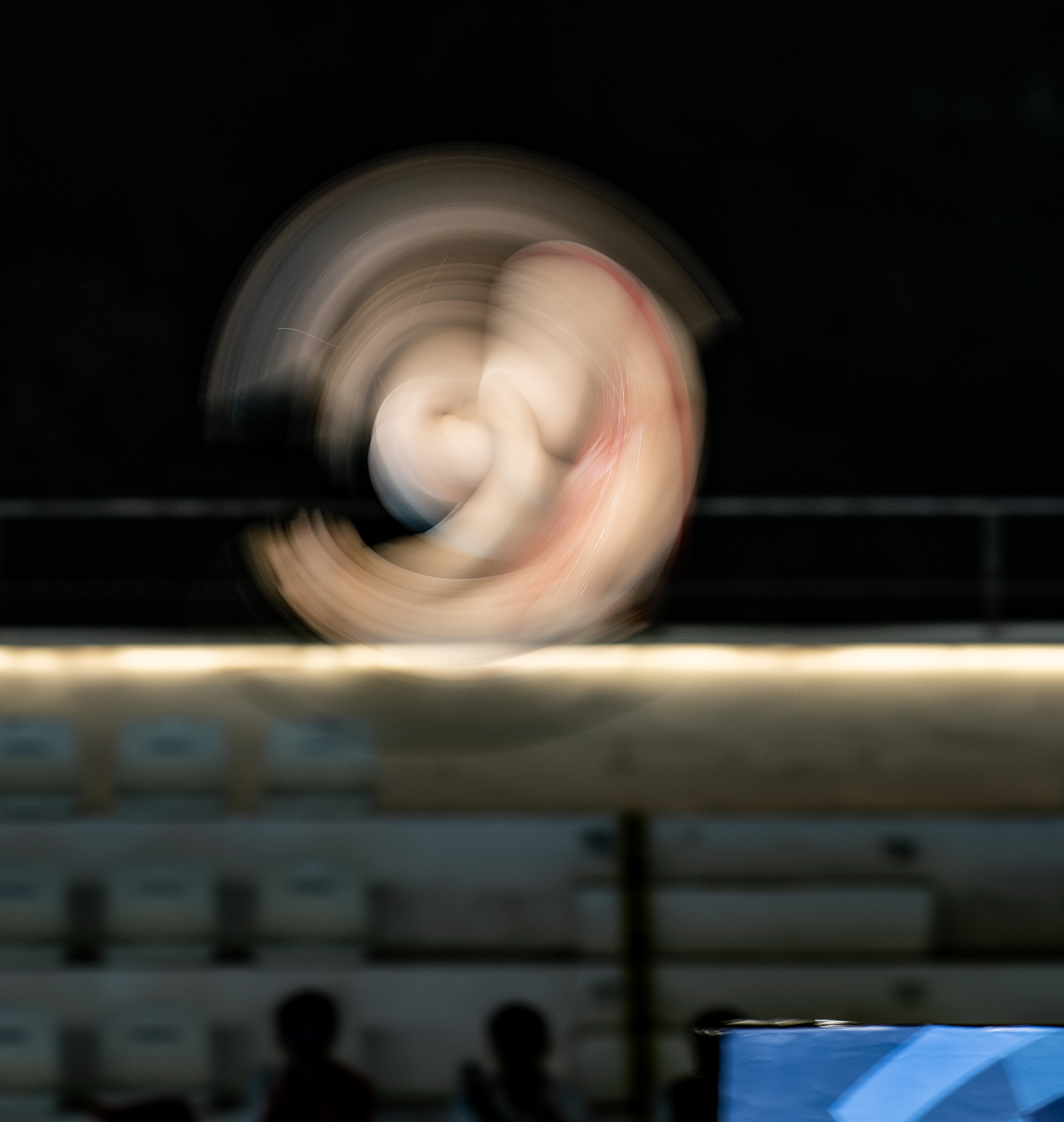 A Chinese diver spins during the 10m Platform Final of the Asian Games at the GBK Aquatic Centre.